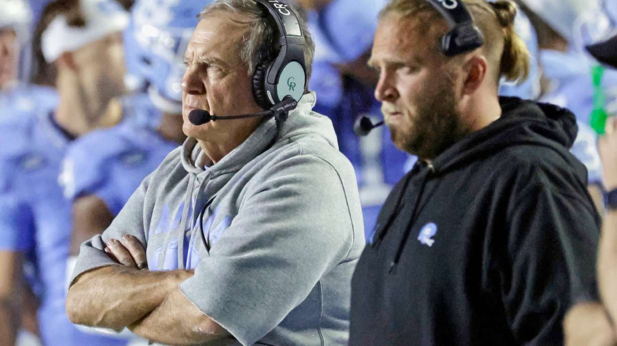North Carolina head coach Bill Belichick, left, and his son, Steve Belicheck, right, the defensive coordinator, watch in the closing minutes of the second half of an NCAA college football game against TCU, Monday, Sept. 1, 2025, in Chapel Hill, N.C.