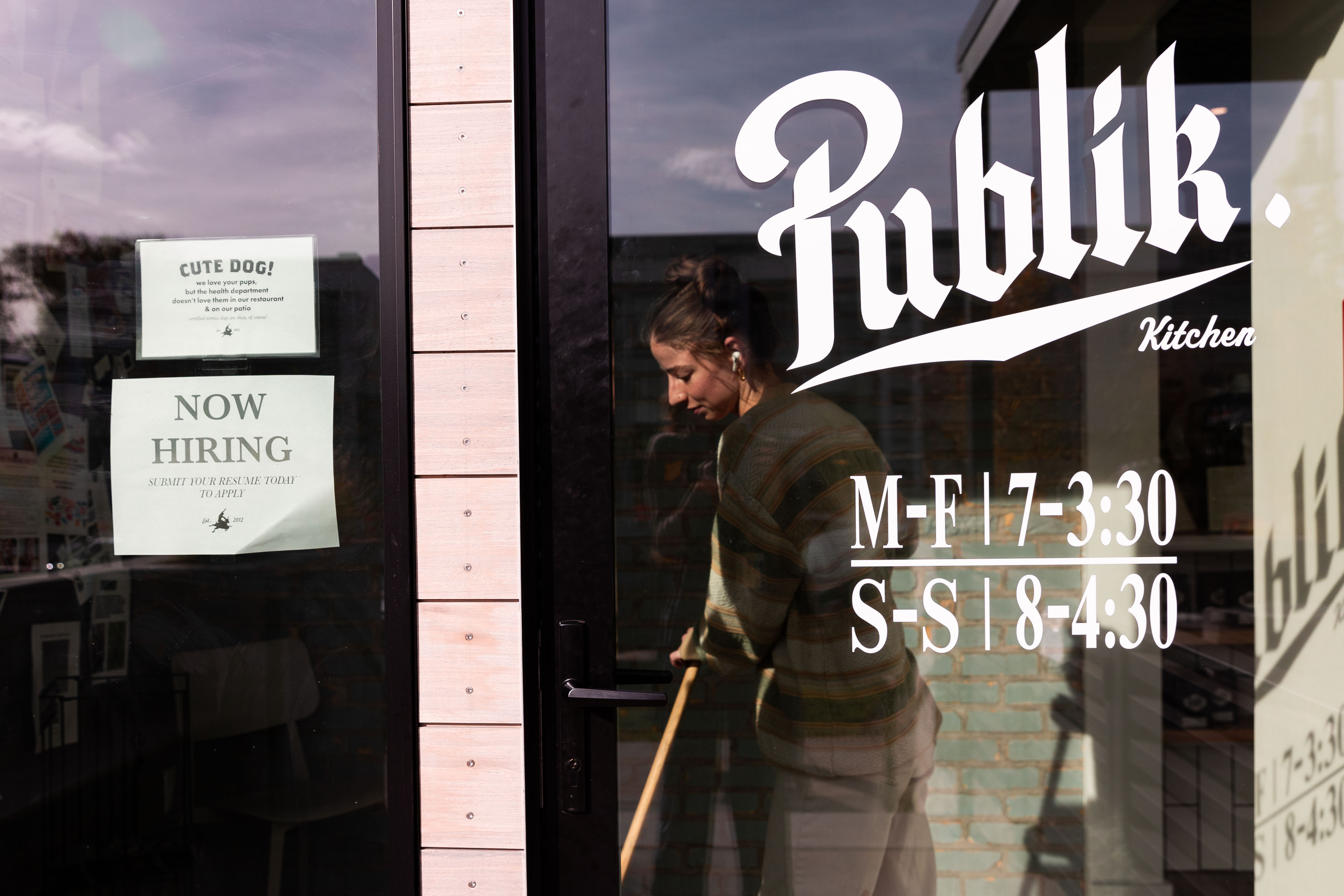 A sign reading “Now hiring” is on the window of Publik Kitchen in Salt Lake City on Nov. 3, 2023.