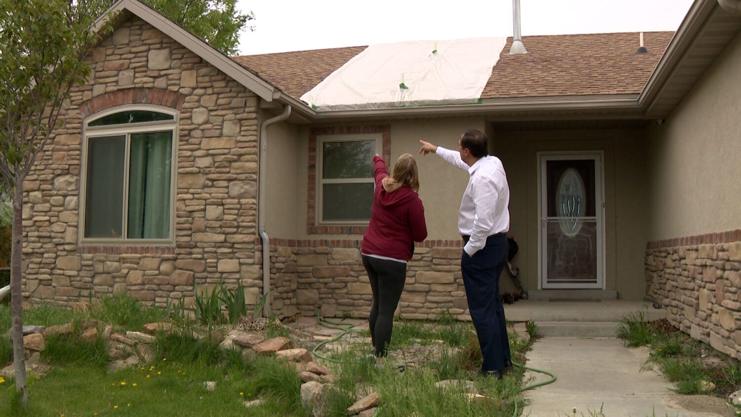Melanie Queen points out to KSL-TV’s Matt Gephardt the damage that’s led to her leaking roof, Tuesday. Queen noticed the unusual sight one year after having her new roof installed.