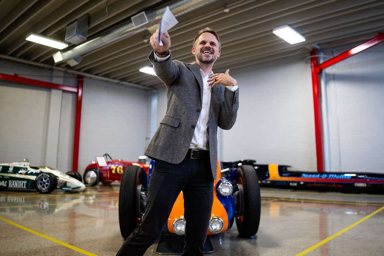 Tim Glenn, museum director for the Museum of Utah, speaks after the Utah Historical Society announced its largest artifact for display in the Museum of Utah, the Mormon Meteor III land speed racer, behind, at the Price Museum Of Speed in Salt Lake City on Wednesday.