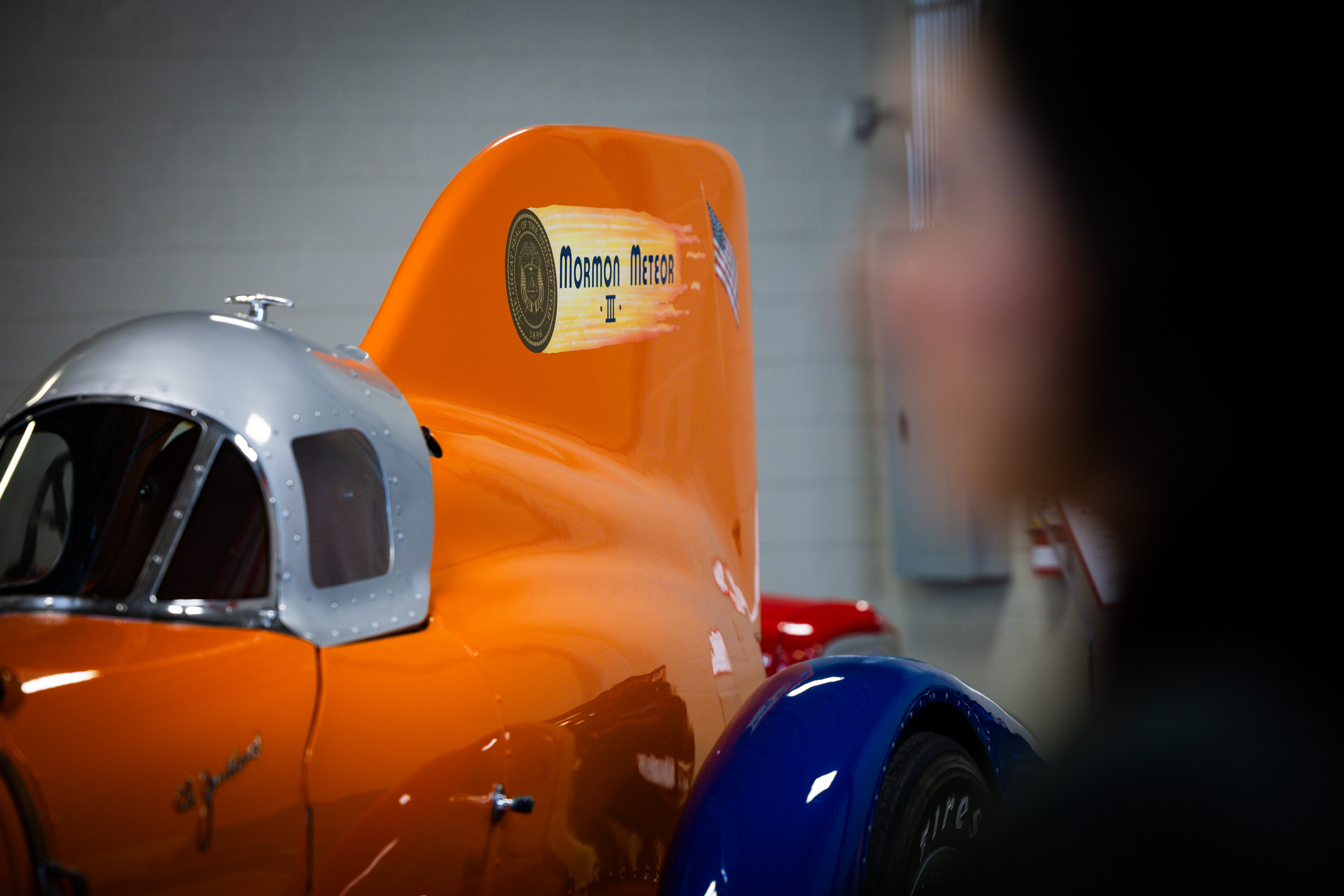 Jennifer Ortiz, director of the Utah Historical Society, announces its largest artifact for display in the Museum of Utah, the Mormon Meteor III land speed racer, at left, at the Price Museum Of Speed in Salt Lake City on Wednesday.