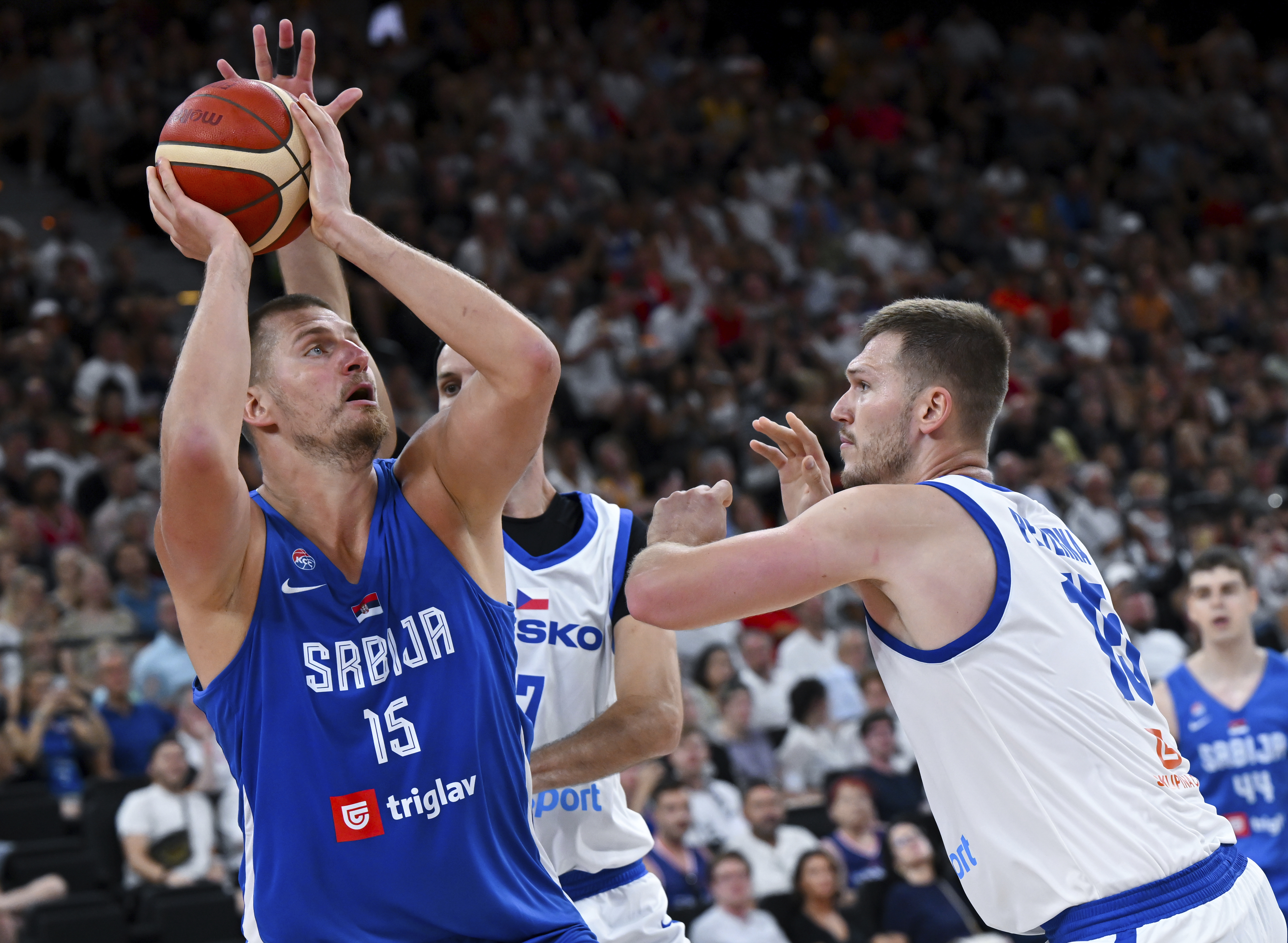 Serbia's Nikola Jokic, left, and Czech Republic's Martin Peterka in action during the Basketball Supercup semifinal between Serbia and Czech Republic, in the SAP Garden, Munich, Germany, Friday Aug. 15, 2025. 