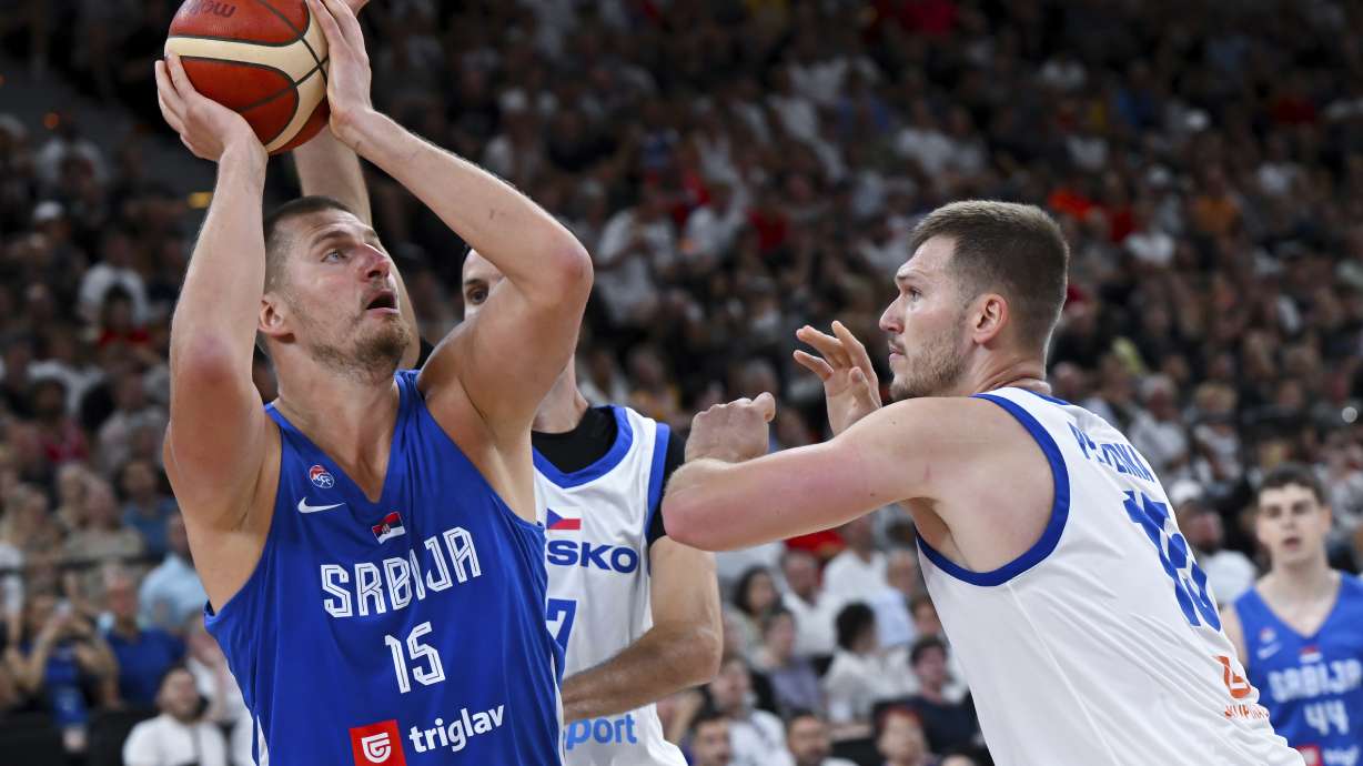 Serbia's Nikola Jokic, left, and Czech Republic's Martin Peterka in action during the Basketball Supercup semifinal between Serbia and Czech Republic, in the SAP Garden, Munich, Germany, Friday Aug. 15, 2025.