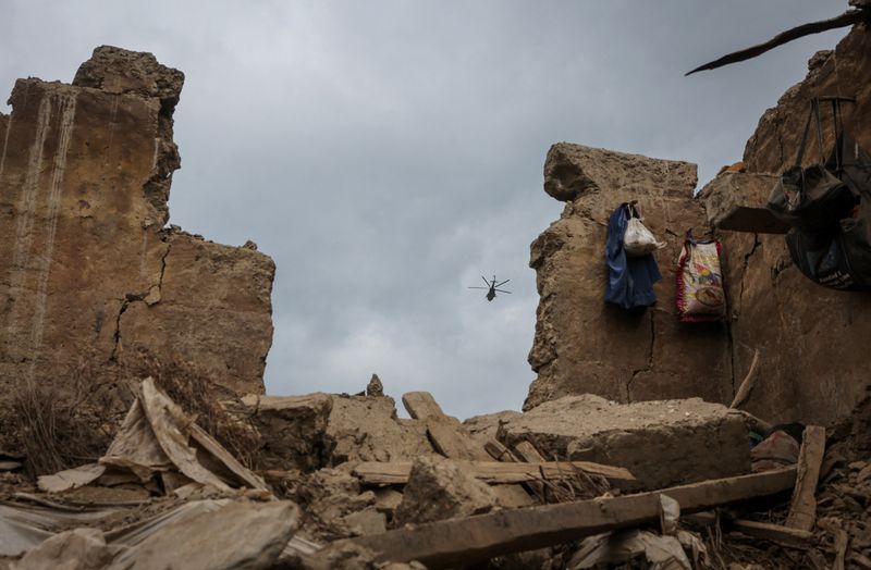 A Taliban military helicopter flies carrying injured victims of a deadly magnitude-6 earthquake that struck Afghanistan on Sunday, in Mazar Dara, Kunar province, Afghanistan, Tuesday. 