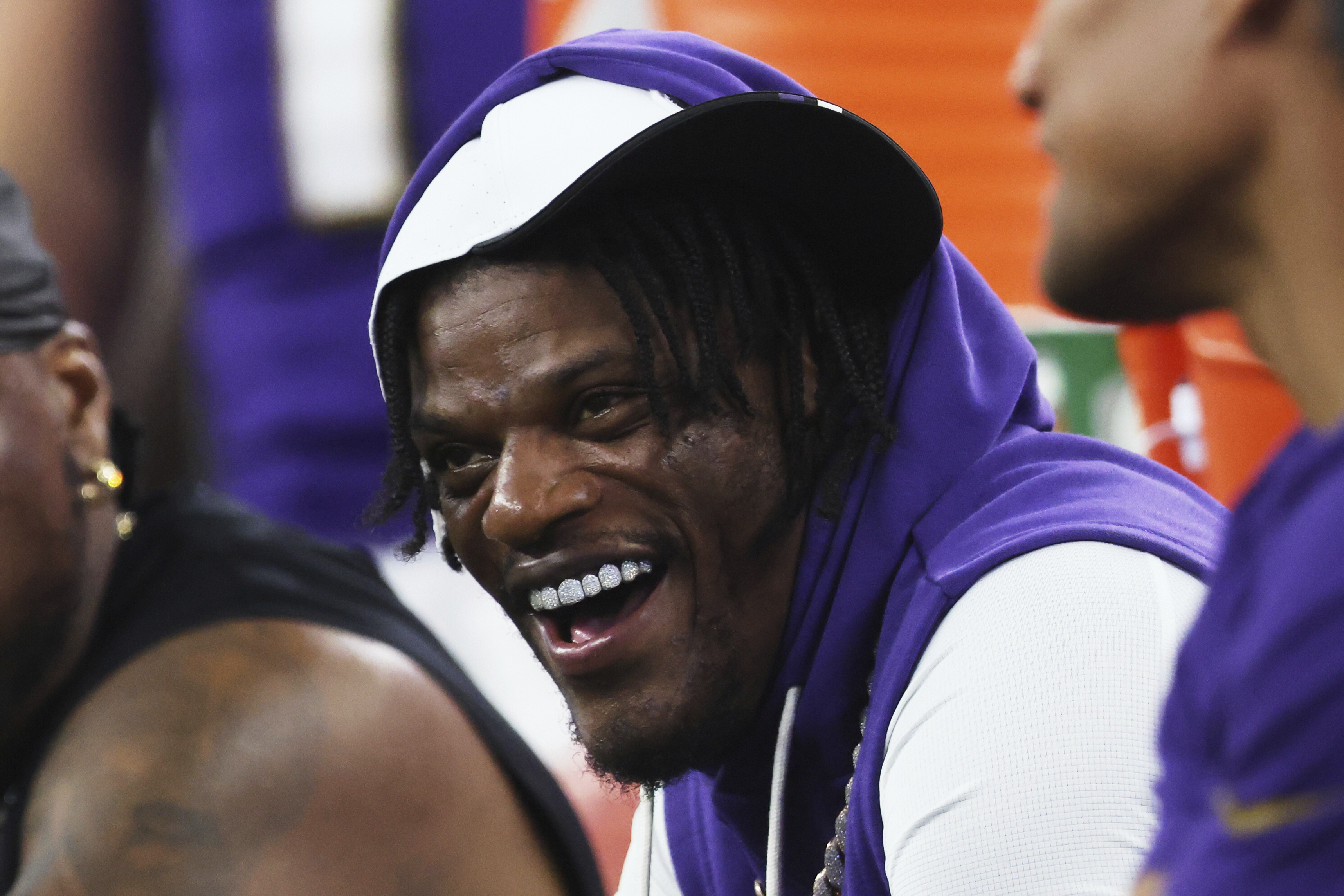 Baltimore Ravens quarterback Lamar Jackson laughs as he talks with teammates on the sideline in the first half of a preseason NFL football game against the Dallas Cowboys Saturday, Aug. 16, 2025, in Arlington, Texas. 