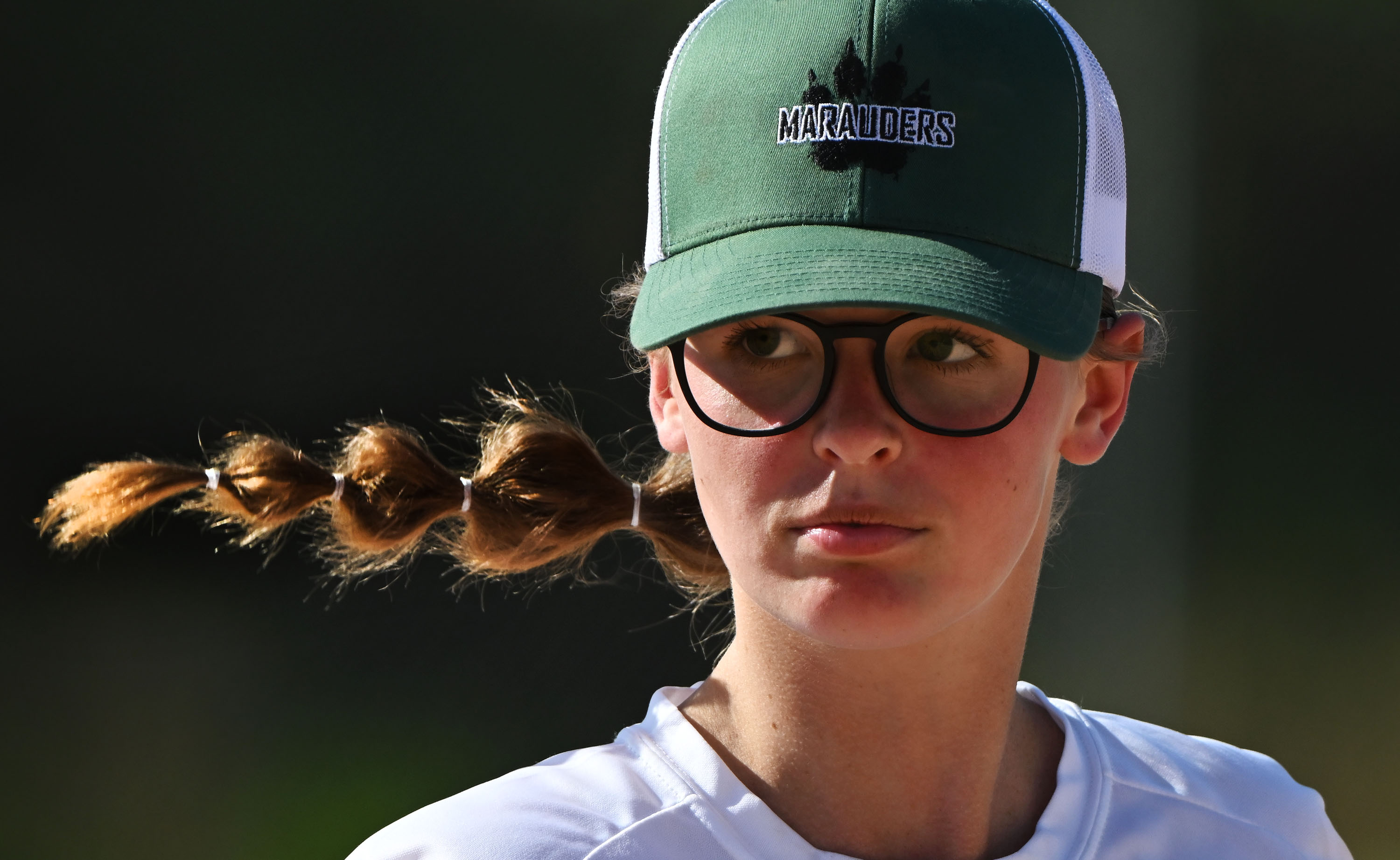 Utah Military Academy’s Ainsley Griner who competes on the boys baseball team looks toward the opposing bench between innings as they play Intermountain Christian Academy in Lehi on Aug. 13.