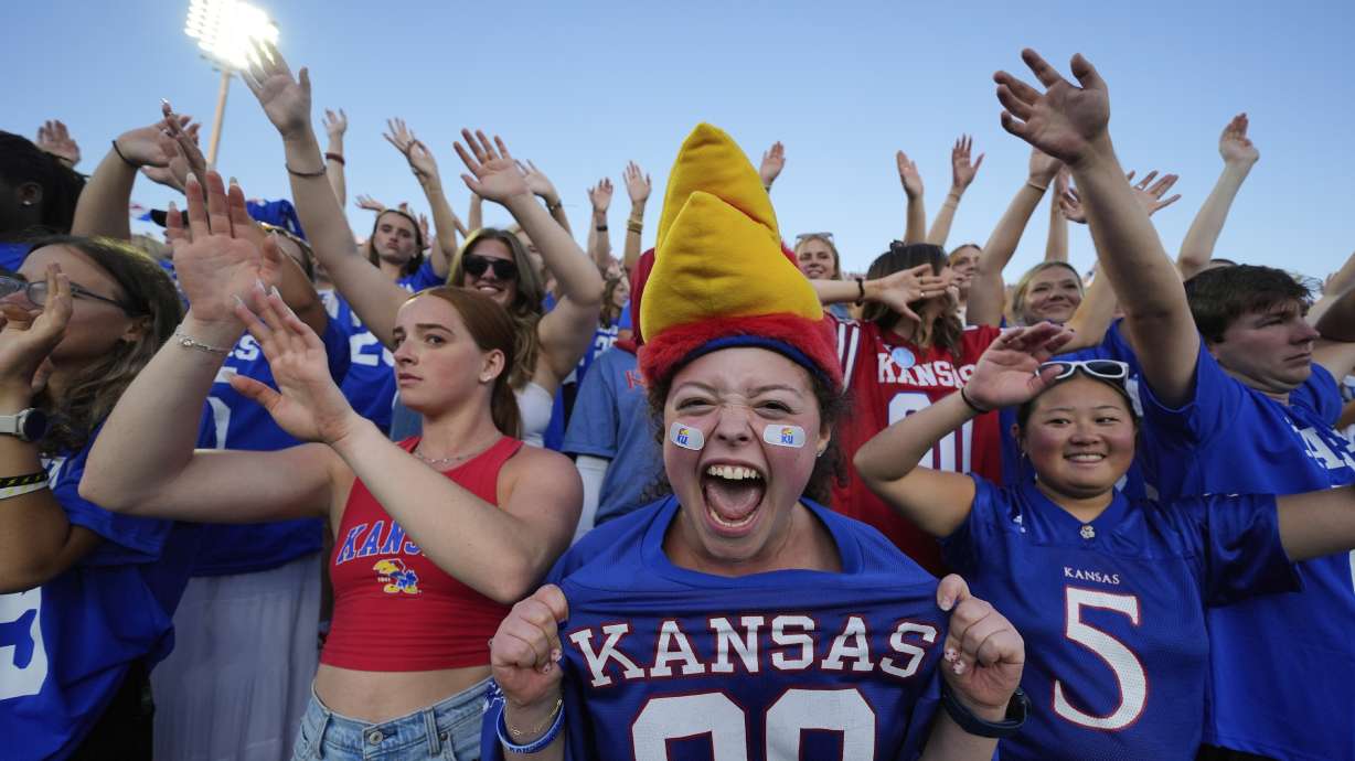 Fans cheer after a Kansas touchdown during the second half of an NCAA college football game against Fresno State Saturday, Aug. 23, 2025, in Lawrence, Kan.