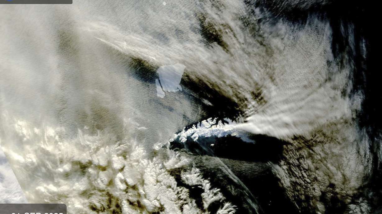 An iceberg, known as A23a, top, seen on a NASA satellite, is visible near South Georgia Island, bottom, on Sept. 1 off the coast of Antarctica.