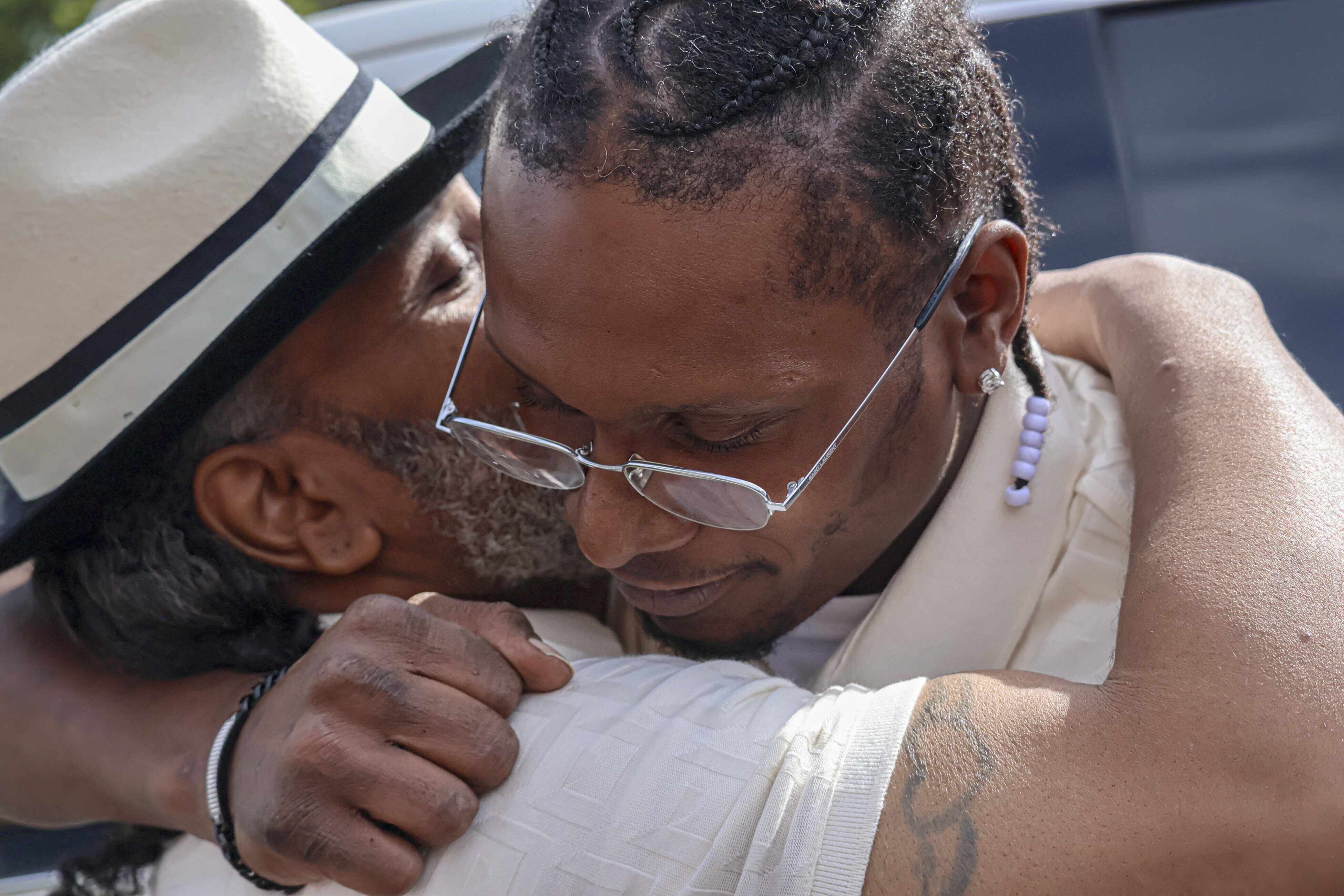 After a judge found him innocent of a 1998 murder, Bryan Hooper, Sr., left, embraces his son Bryan Hooper, Jr., outside Stillwater Prison on Thursday in Bayport, Minn. 