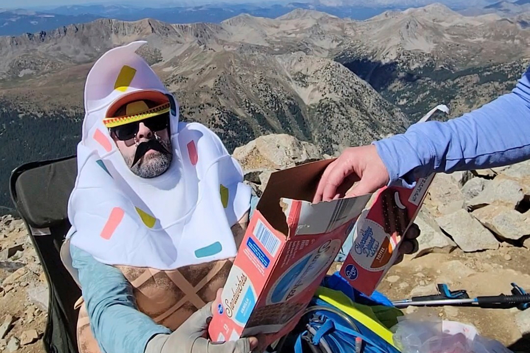 A man shares ice cream he carried up Huron Peak packed in dry ice with fellow hikers in Chaffee County, Colo., Aug. 31.