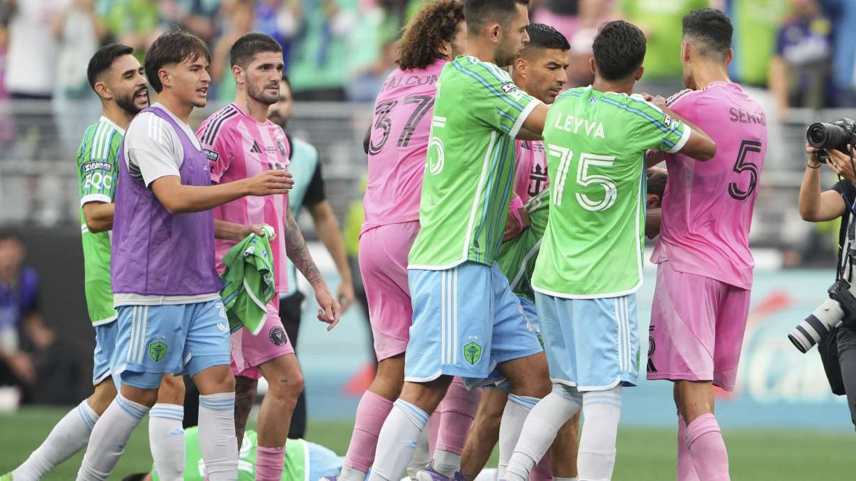 Seattle Sounders midfielder Obed Vargas, bottom left, lies on the ground after being pushed during an altercation against Inter Miami, including forward Luis Suárez and midfielder Sergio Busquets (5) after the Sounders won a Leagues Cup final soccer match Sunday, Aug. 31, 2025, in Seattle.