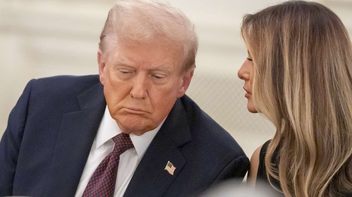President Donald Trump listens as first lady Melania Trump repeats a question for him during a dinner in the State Dinning Room of the White House, Thursday, Sept. 4, 2025, in Washington.