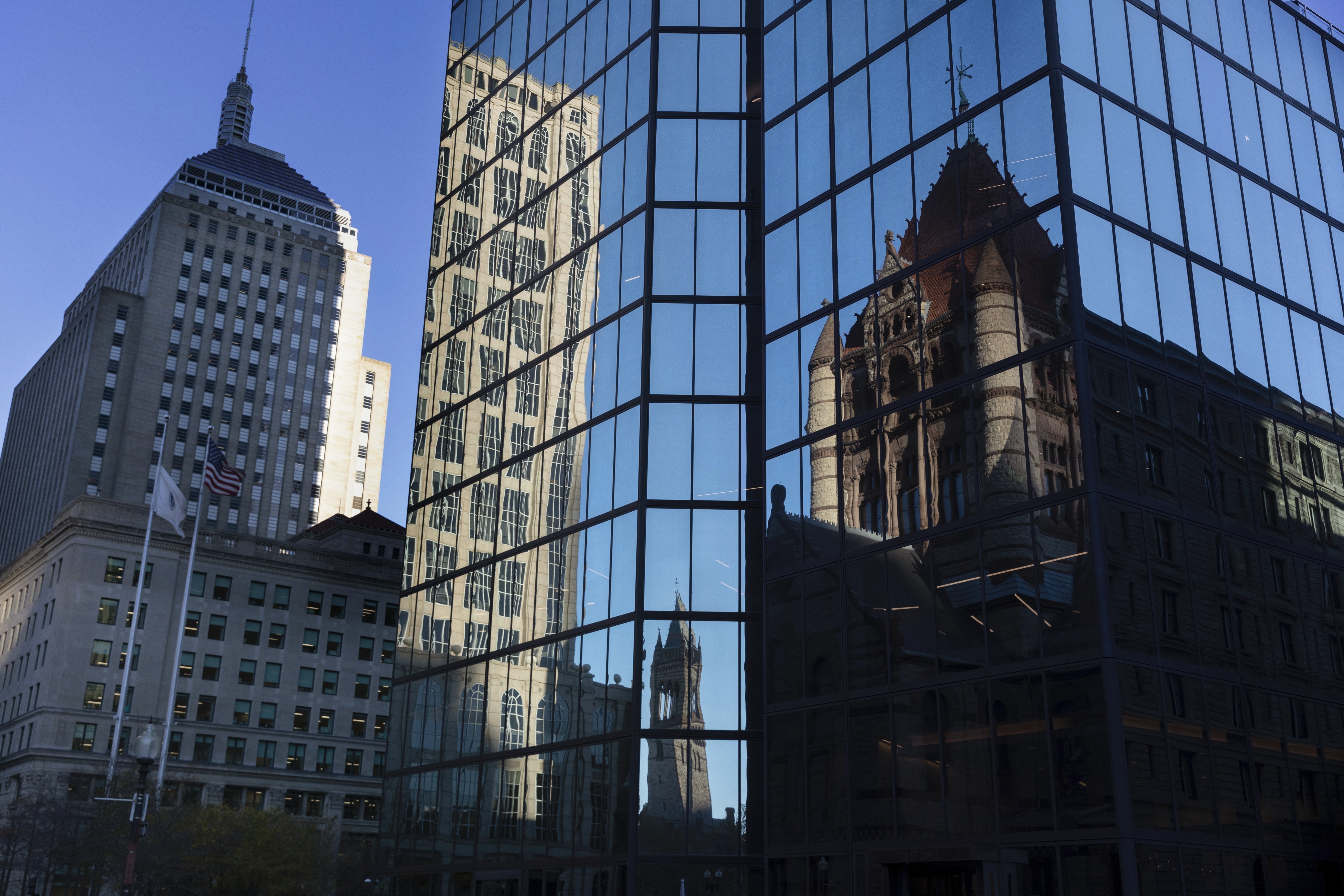 FILE - Buildings are reflected in 200 block of Clarendon Street, Nov. 8, 2022, in Boston. 
