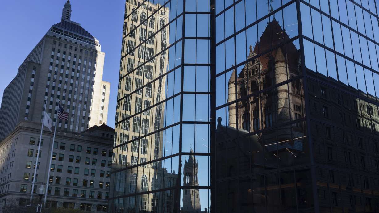 FILE - Buildings are reflected in 200 block of Clarendon Street, Nov. 8, 2022, in Boston.