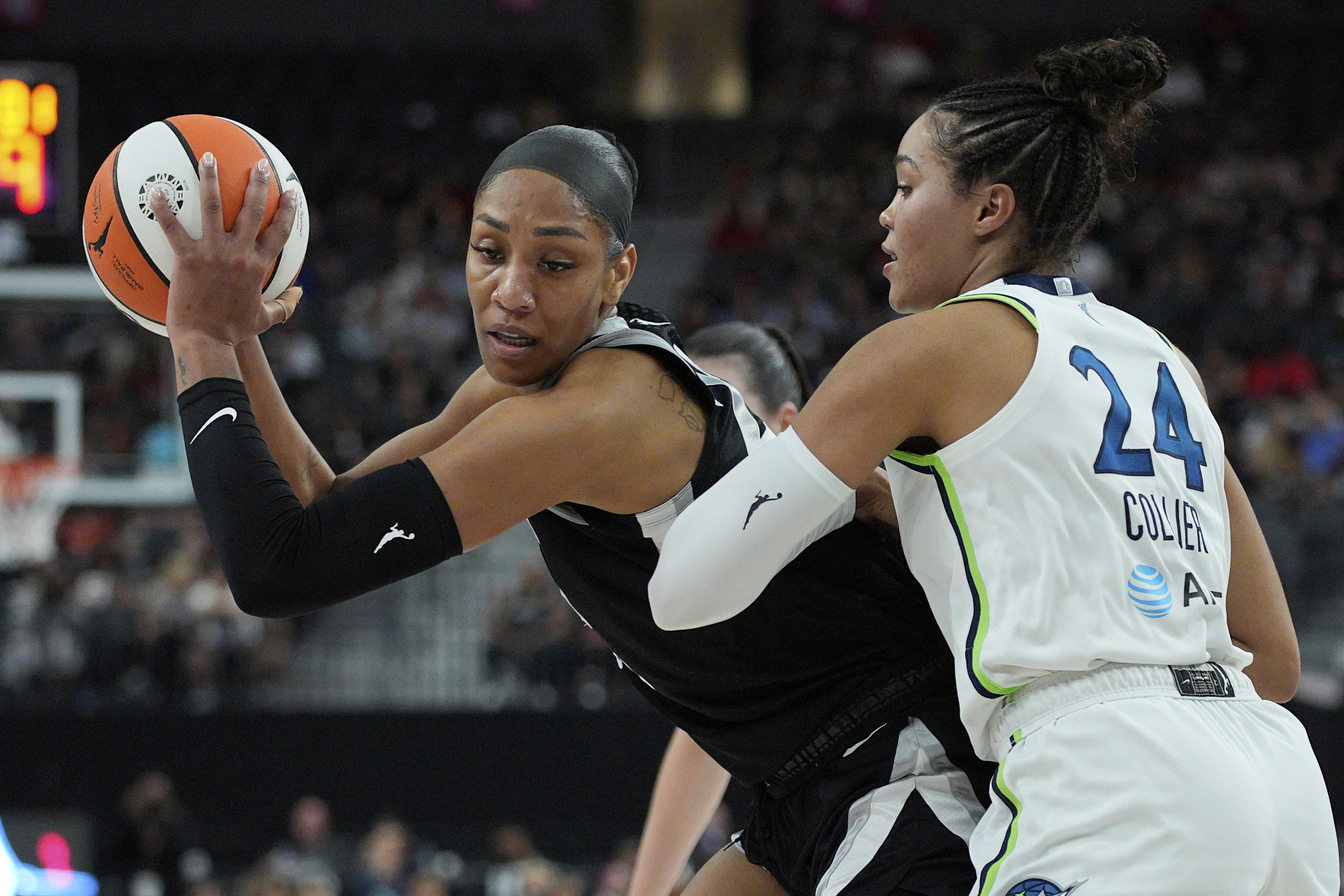 Las Vegas Aces center A'ja Wilson, left, drives against Minnesota Lynx forward Napheesa Collier (24) during the first half of a WNBA basketball game Thursday, Sept. 4, 2025, in Las Vegas. 