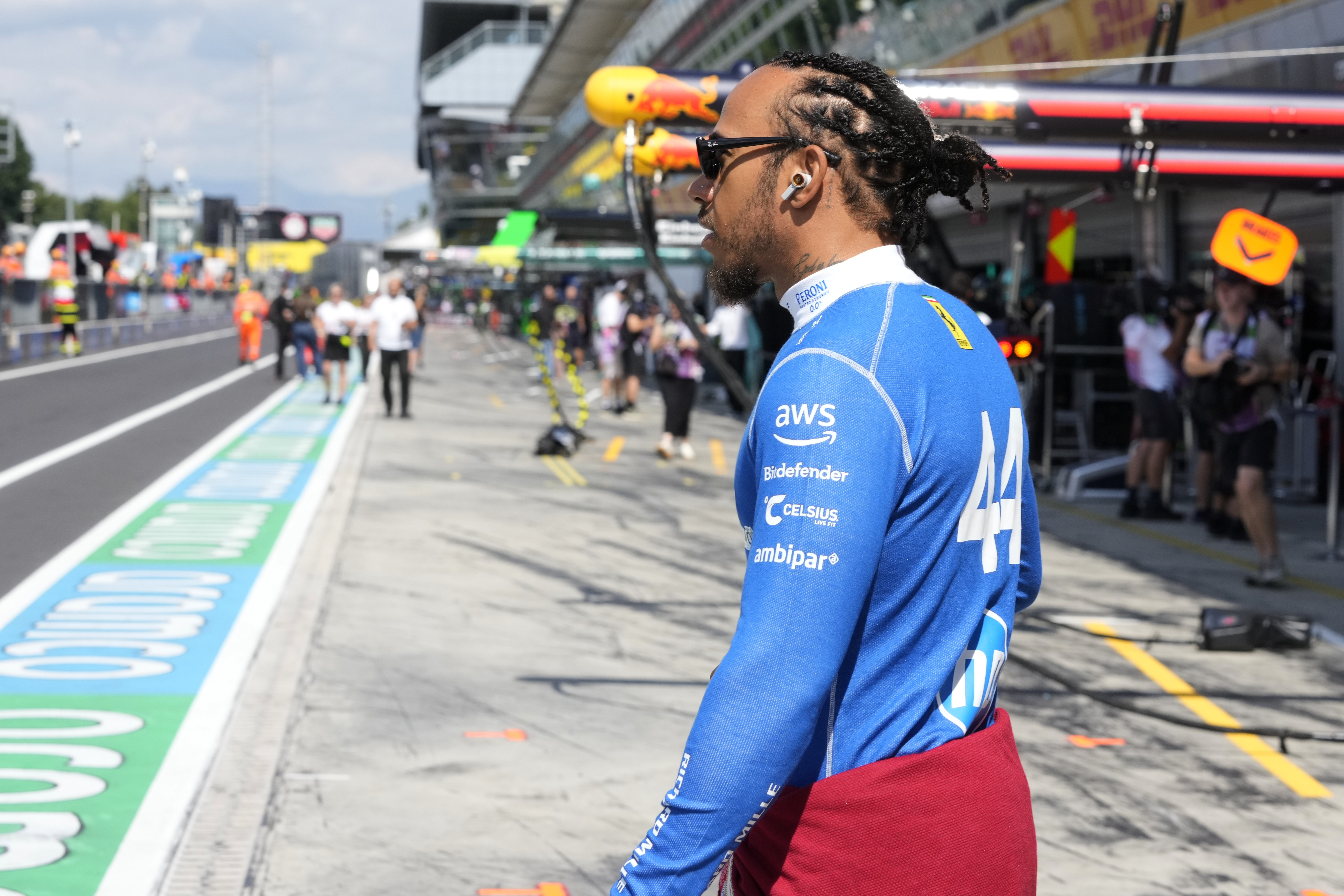 Ferrari driver Lewis Hamilton of Britain walks through the pits before the first free practice ahead of the Italian Grand Prix at the Monza racetrack in Monza, Italy, Friday, Sept. 5, 2025.