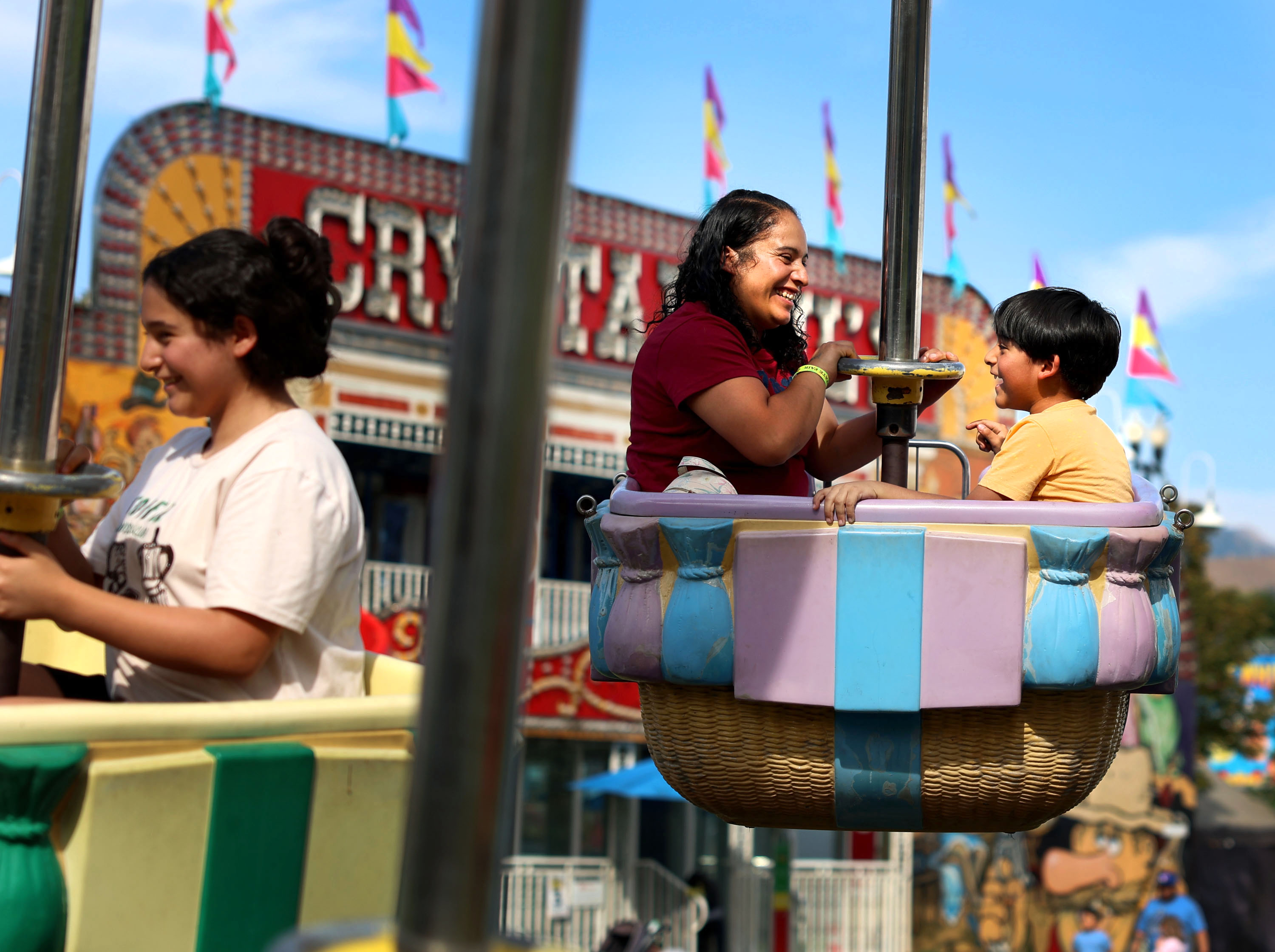 Guadalupe Bravo, center, and her children, daughter Katherine Batalla and son Erik Batalla, enjoy a ride during the first day of the Utah State Fair at the Utah State Fairpark in Salt Lake City on Thursday.
