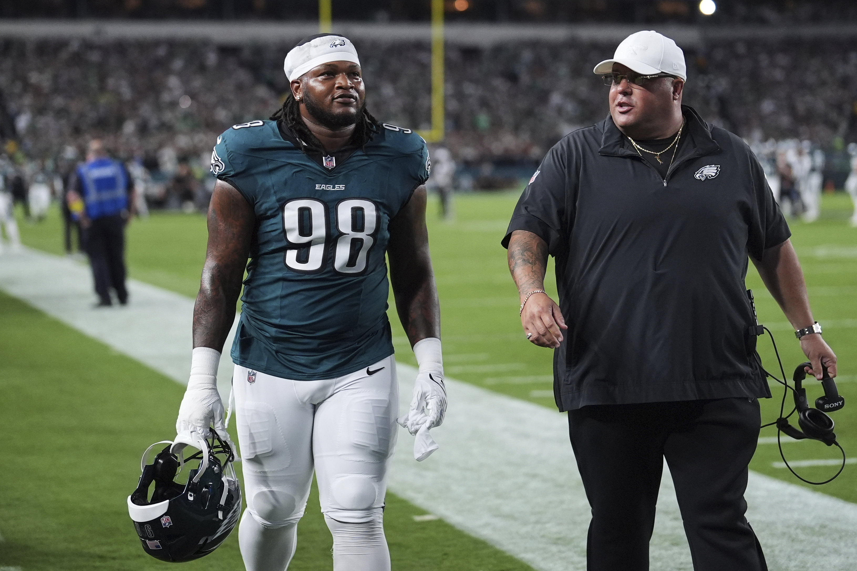Philadelphia Eagles defensive tackle Jalen Carter (98) walks off the field after being disqualified for unsportsman like conduct before an NFL football game against the Dallas Cowboys Thursday, Sept. 4, 2025, in Philadelphia. 