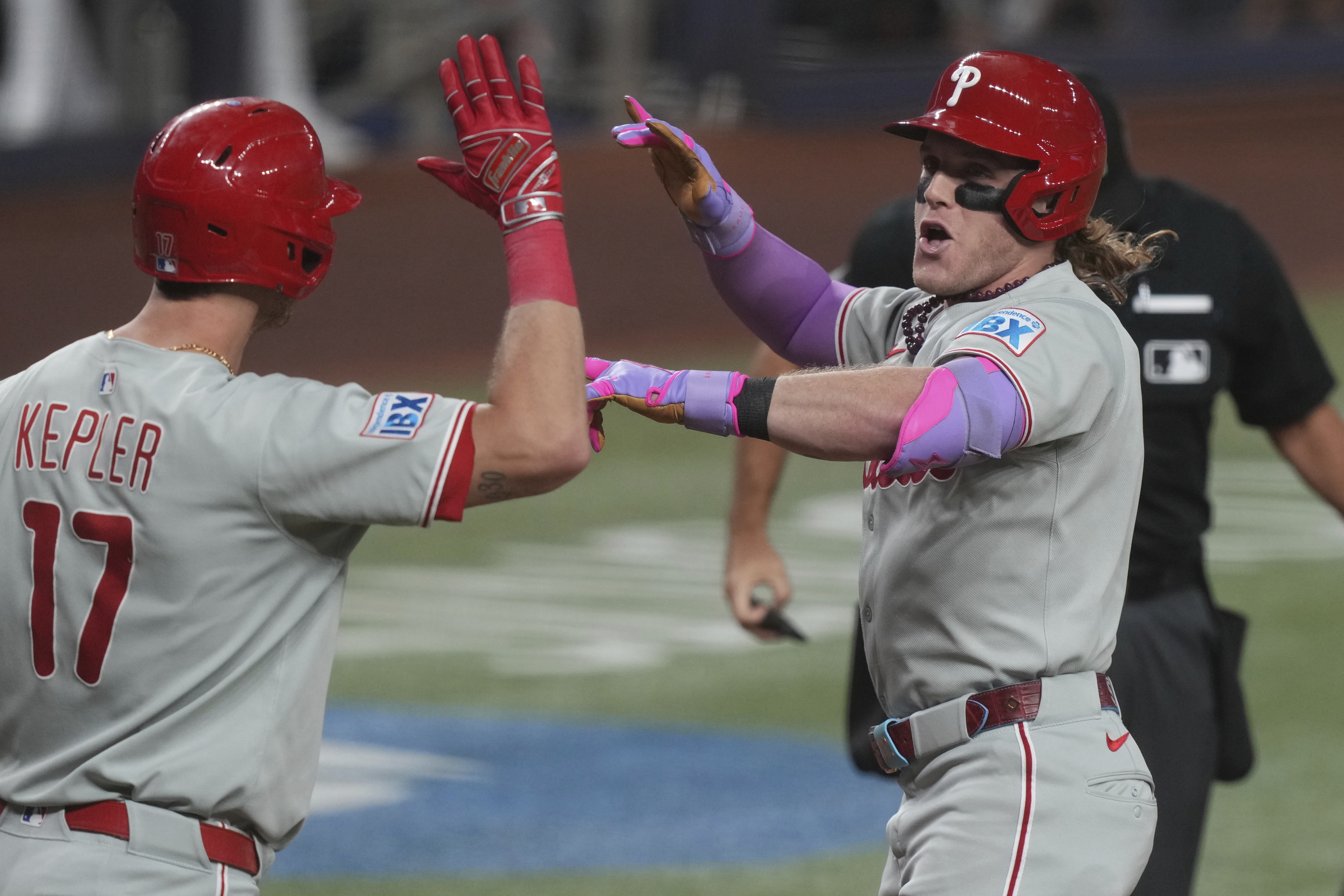 Philadelphia Phillies' Harrison Bader, right, celebrates with Max Kepler (17) after hitting a home run during the fourth inning of a baseball game against the Miami Marlins Friday, Sept. 5, 2025, in Miami. 