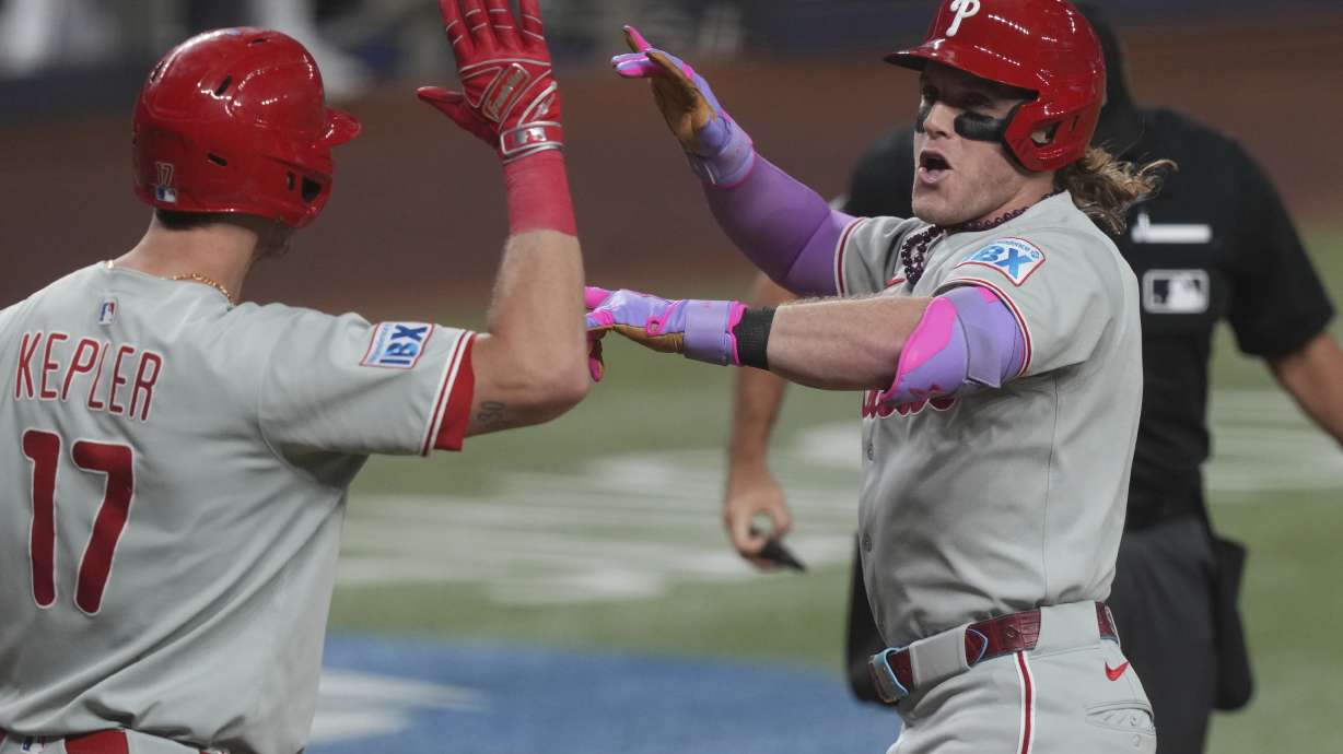 Philadelphia Phillies' Harrison Bader, right, celebrates with Max Kepler (17) after hitting a home run during the fourth inning of a baseball game against the Miami Marlins Friday, Sept. 5, 2025, in Miami.