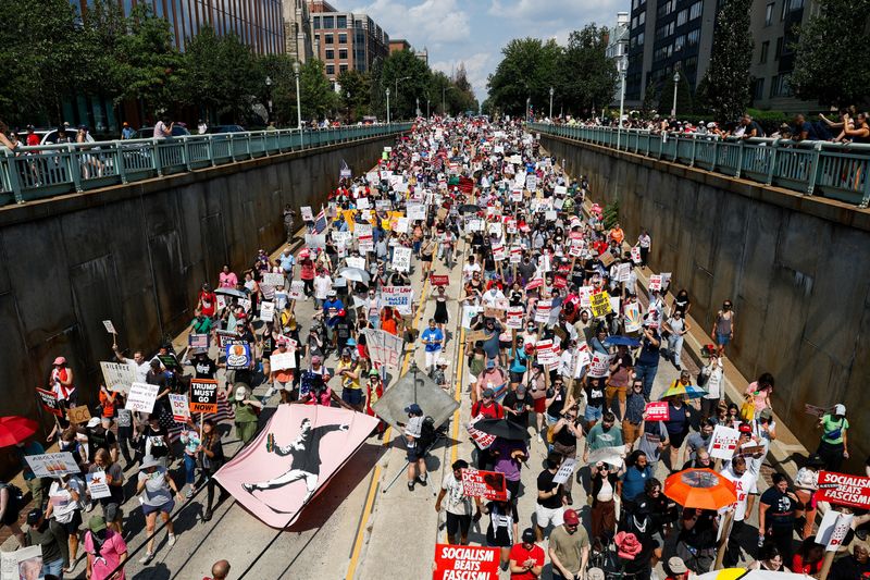 Demonstrators attend the "We Are All D.C." march in Washington Saturday. Several thousand protesters marched demanding an end to the deployment of the National Guard.