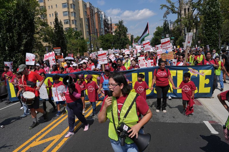 Demonstrators attend the "We Are All D.C." march in Washington Saturday. Several thousand protesters marched demanding an end to the deployment of the National Guard.