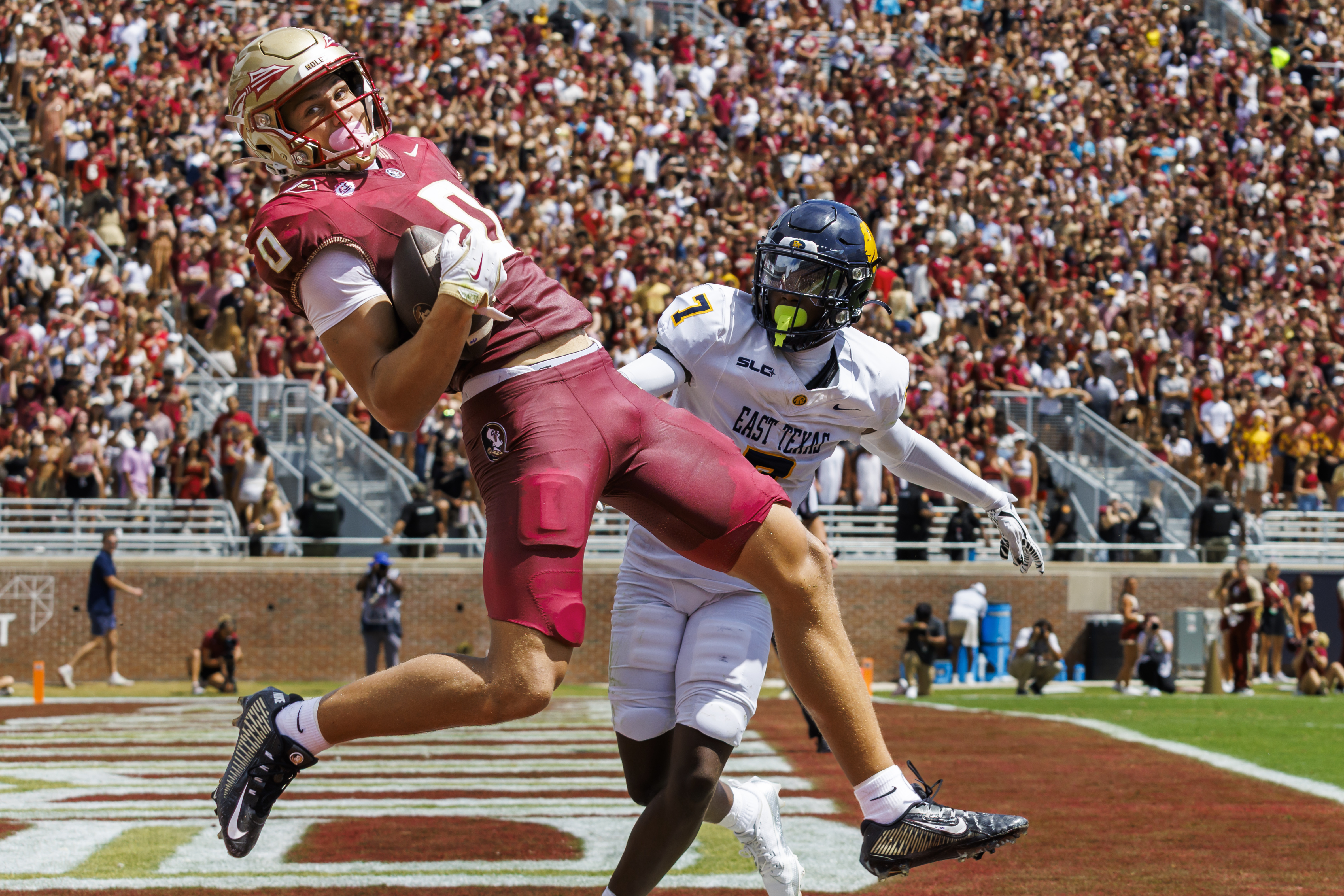 Florida State wide receiver Duce Robinson (0) makes a touchdown catch in front of East Texas A&M defensive back Javon Gillespie (7) during the first half of an NCAA college football game, Saturday, Sept. 6, 2025, in Tallahassee, Fla.