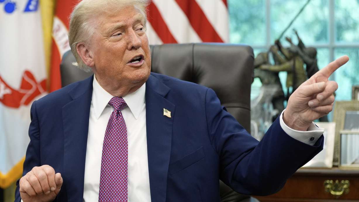 President Donald Trump point to a G20 Miami 2026 poster as he speaks in the Oval Office of the White House, Friday, Sept. 5, 2025, in Washington.