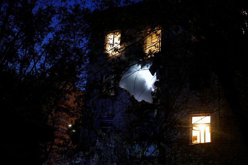 A firefighter works at the site of an apartment building damaged during a Russian drone strike, amid Russia’s attack on Ukraine, in Kyiv, Ukraine Sunday.