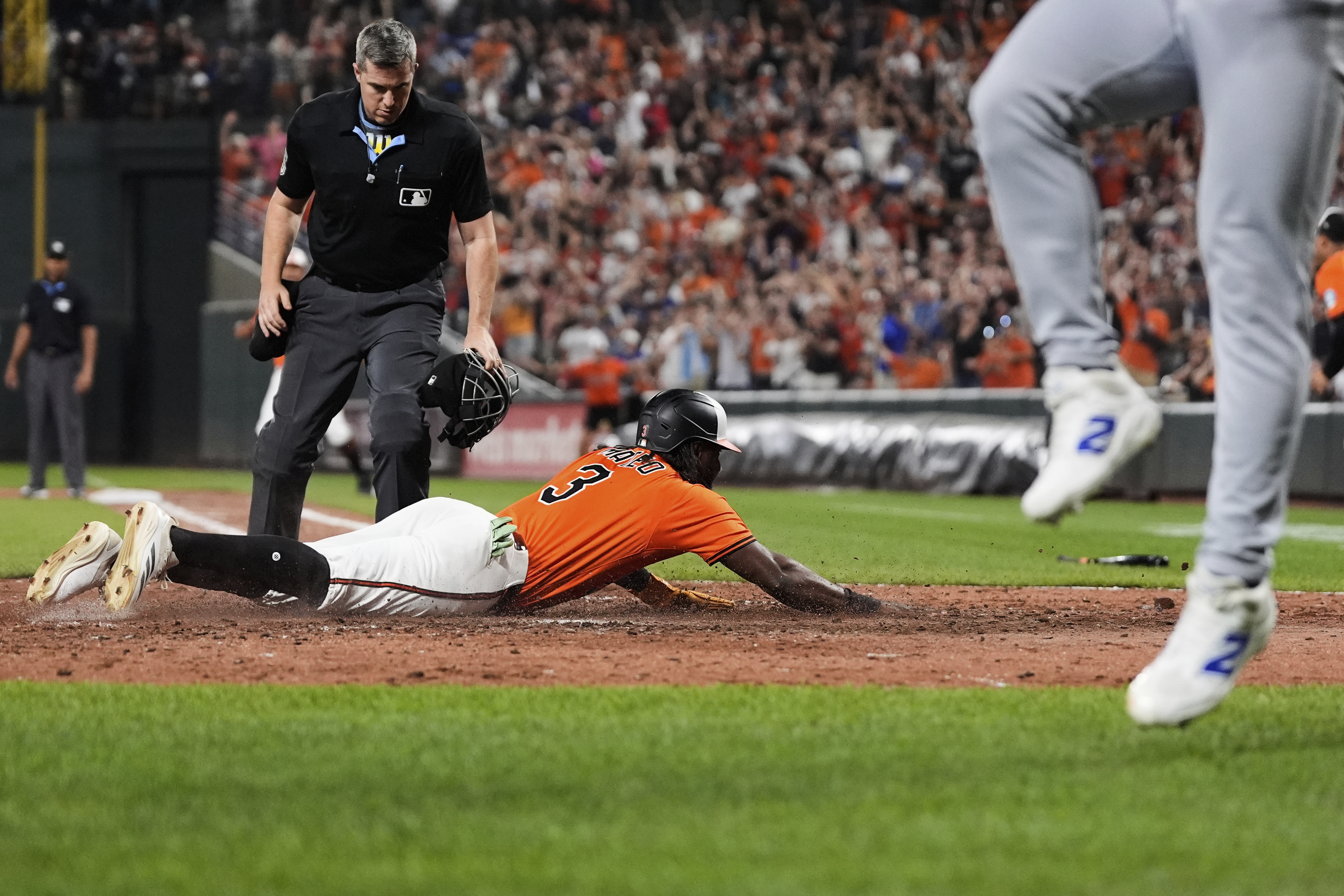 Baltimore Orioles' Jorge Mateo (3) slides into home plate to score on a walk-off single hit by Emmanuel Rivera during the ninth inning of a baseball game against the Los Angeles Dodgers, Saturday, Sept. 6, 2025, in Baltimore. 