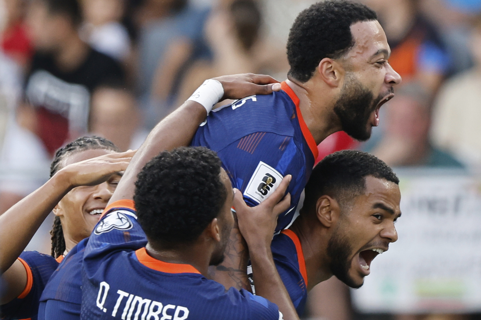 Dutch players celebrate their side's first goal scored by Memphis Depay, top, during the World Cup qualifying soccer match between Lithuania and Netherlands at Darius and Girenas stadium in Kaunas, Lithuania, Sunday, Sept. 7, 2025.