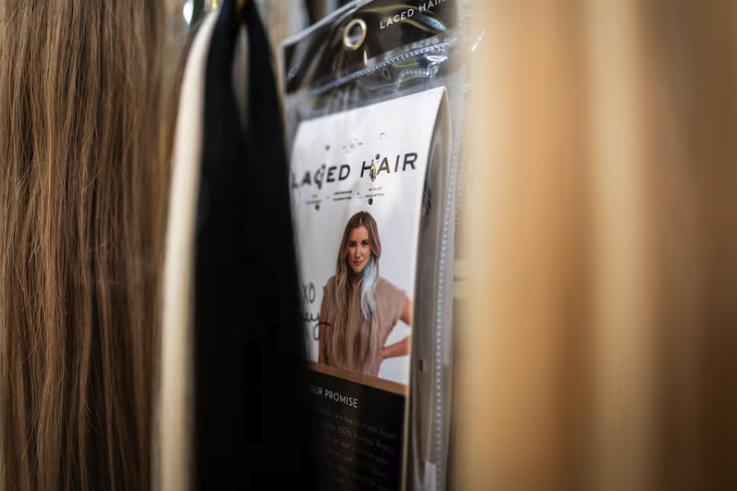 Hair extensions are on display with Lacy Gadegaard-West, CEO of Laced Hair Extensions, on the packaging at her store’s headquarters ahead of the Laced Hair Foundation’s fourth annual Hair for Hope Gala, a charity gala to give away hair extensions to women in need in Salt Lake City on Tuesday.