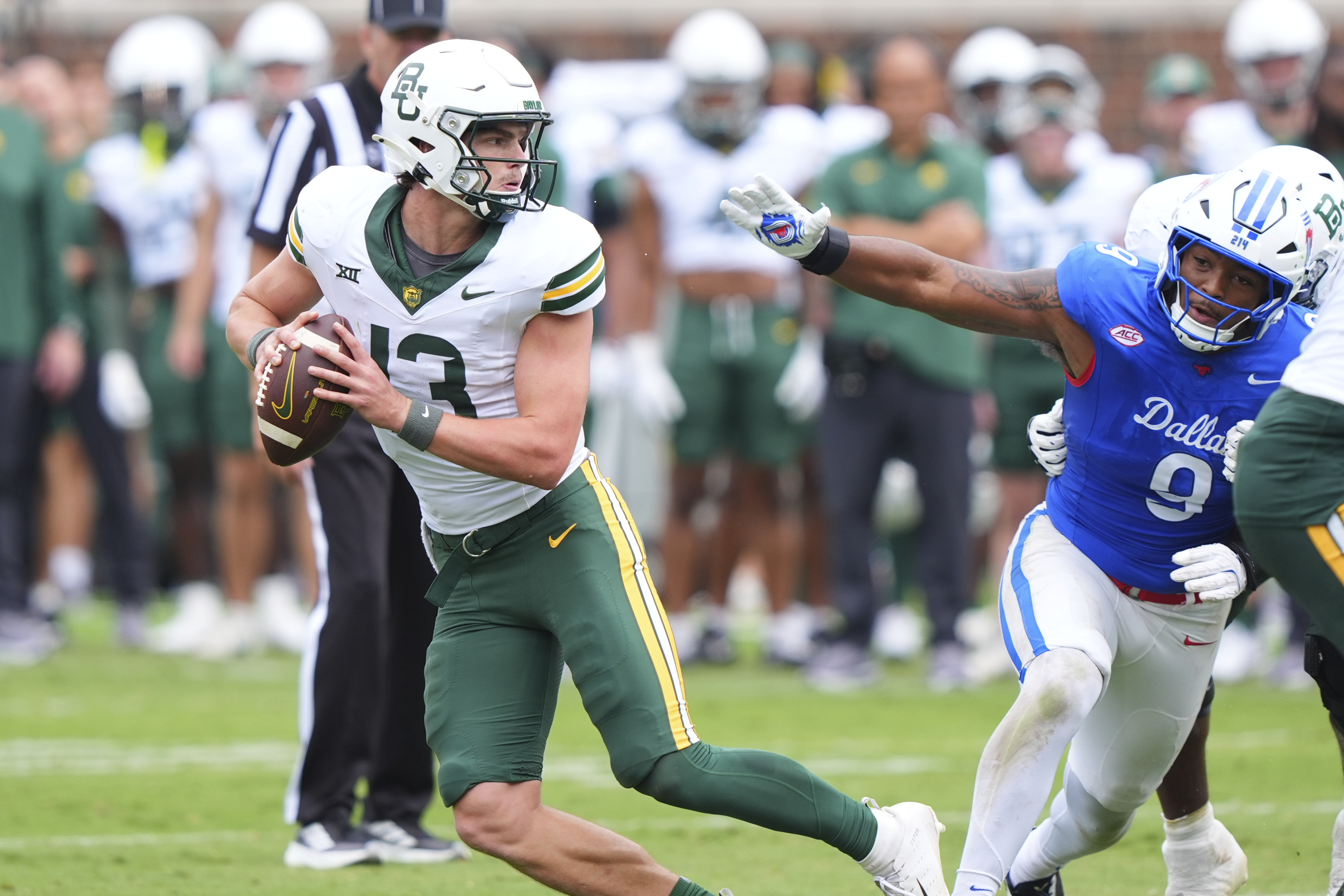 Baylor quarterback Sawyer Robertson (13) eludes SMU defensive end Cameron Robertson (9) during the second half of an NCAA college football game Saturday, Sept. 6, 2025, in Dallas.