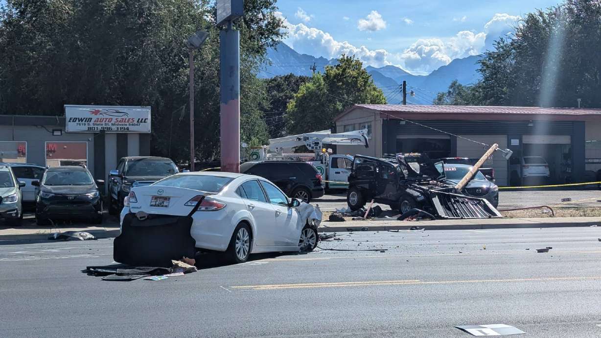 Crews work at the scene of a car crash at 7651 S. State Street in Midvale on Monday. The collision killed a pedestrian and critically injured two drivers, police said.
