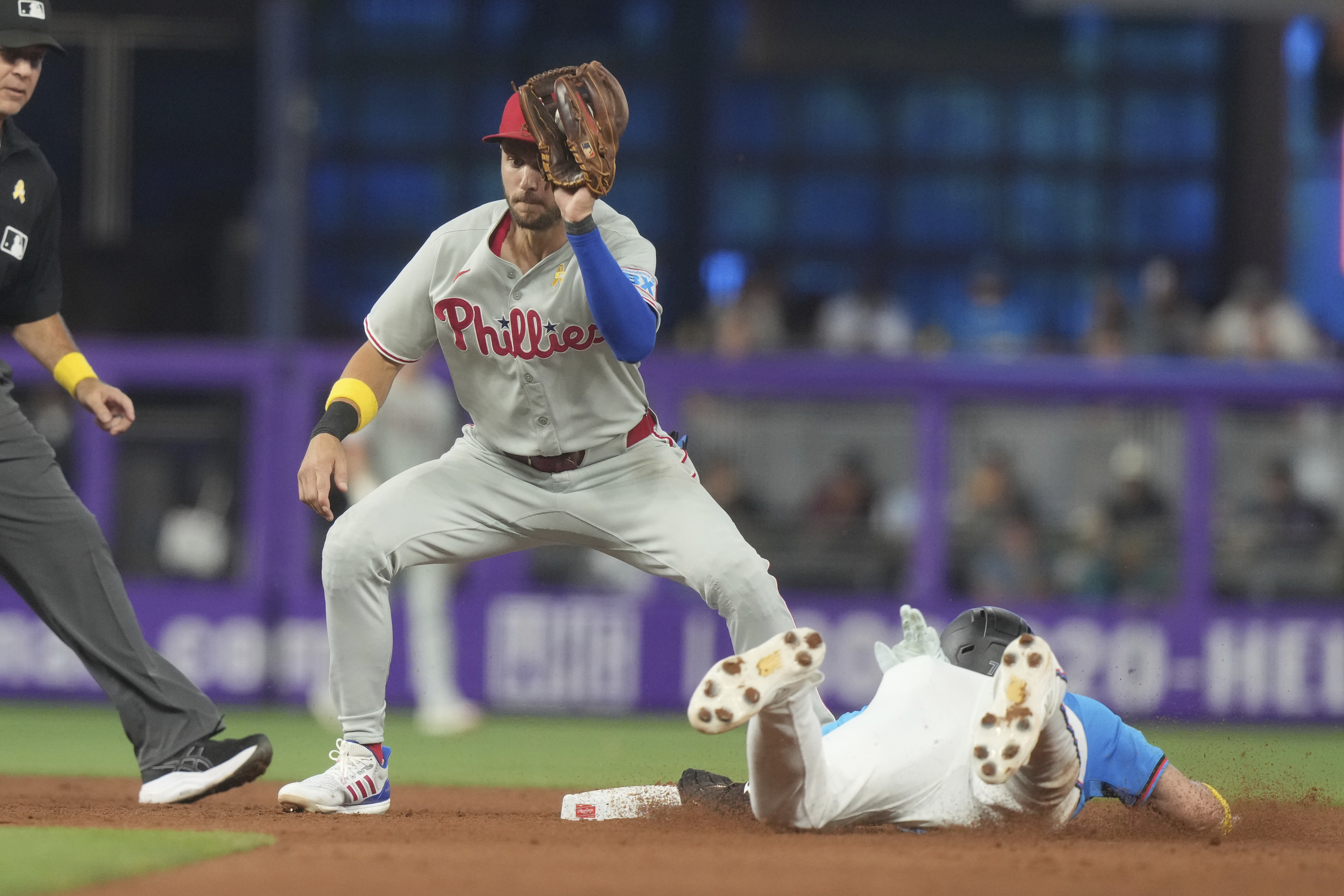 Philadelphia Phillies short stop Trea Turner is late with the tag as Miami Marlins' Troy Johnston steals second base during the sixth inning of a baseball game Sunday, Sept. 7, 2025, in Miami. 