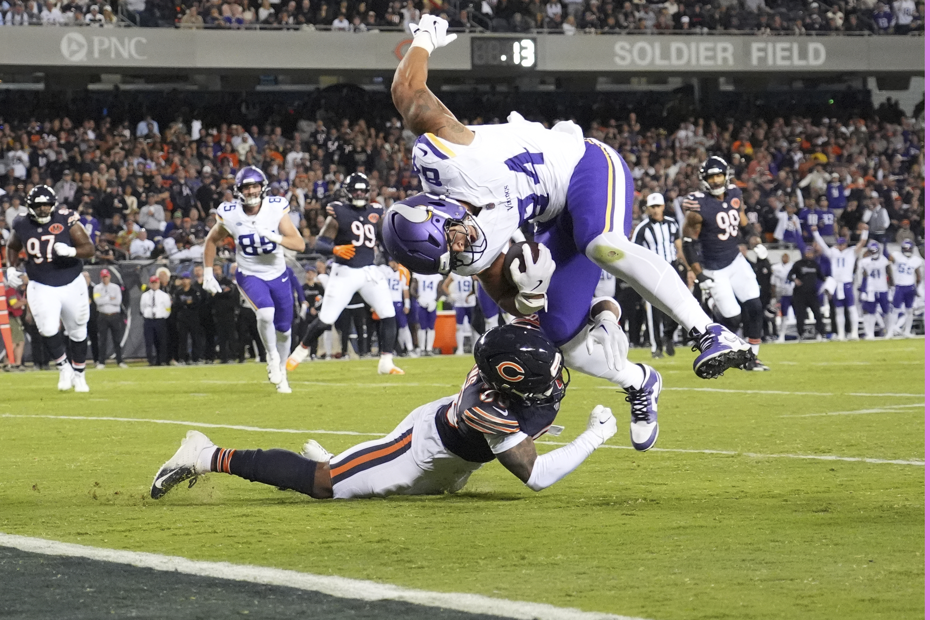 Minnesota Vikings tight end Josh Oliver, right, is stopped short of the end zone by Chicago Bears defensive back Jonathan Owens during the second half of an NFL football game Monday, Sept. 8, 2025, in Chicago. 