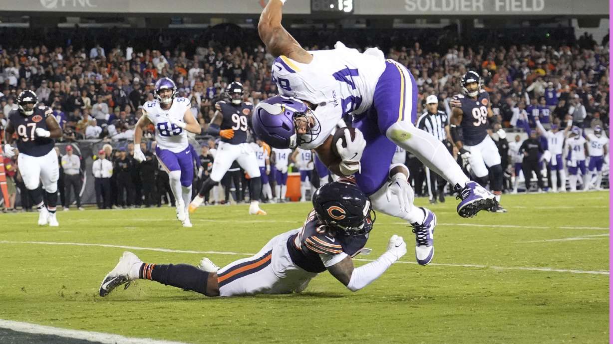 Minnesota Vikings tight end Josh Oliver, right, is stopped short of the end zone by Chicago Bears defensive back Jonathan Owens during the second half of an NFL football game Monday, Sept. 8, 2025, in Chicago.