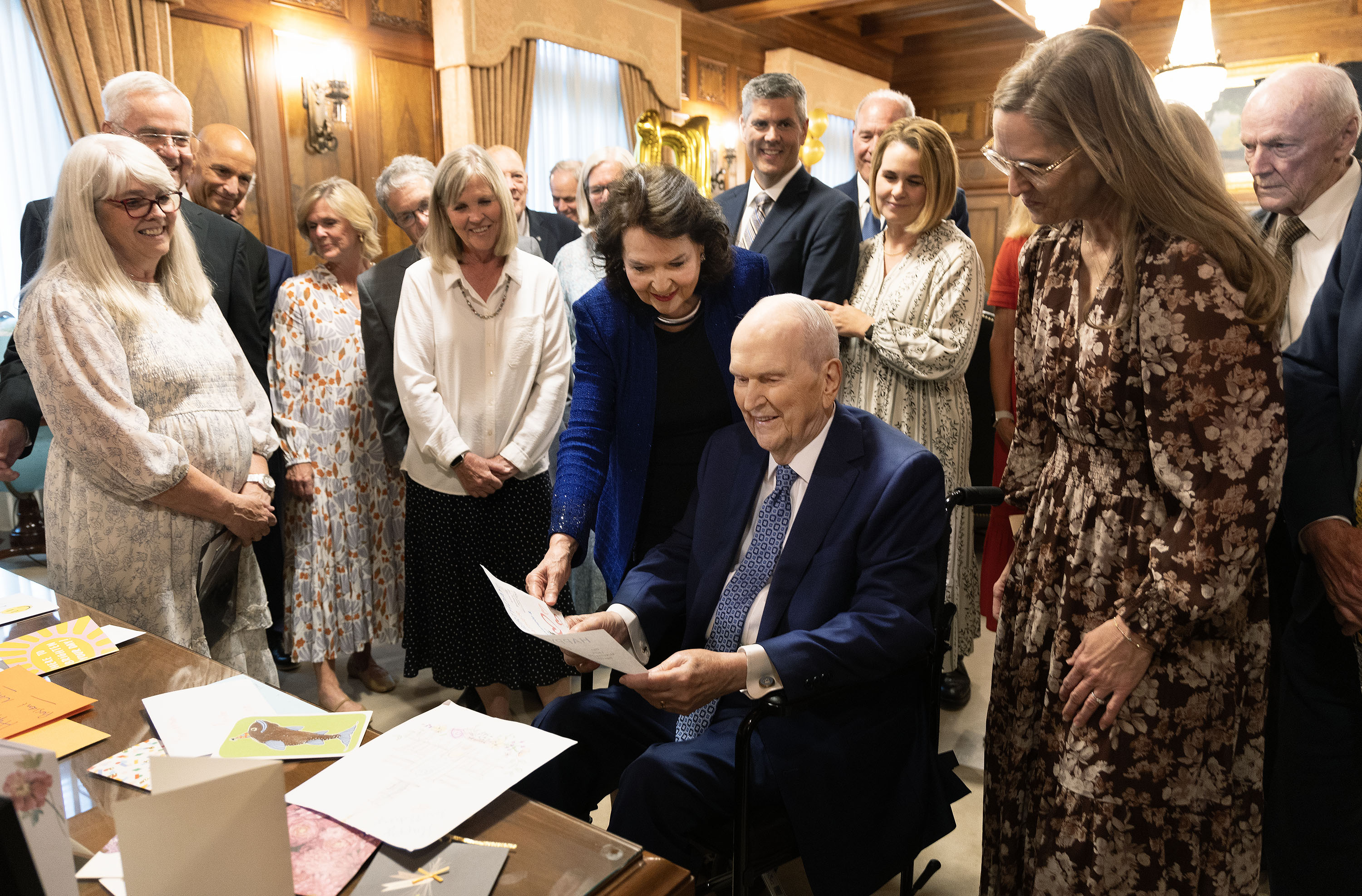 President Russell M. Nelson of The Church of Jesus Christ of Latter-day Saints and his wife, Sister Wendy Nelson, reads cards and messages while surrounded by his children and their spouses in celebrating his 101st birthday at the Church Administration Building in Salt Lake City on Sunday, Sept. 7.