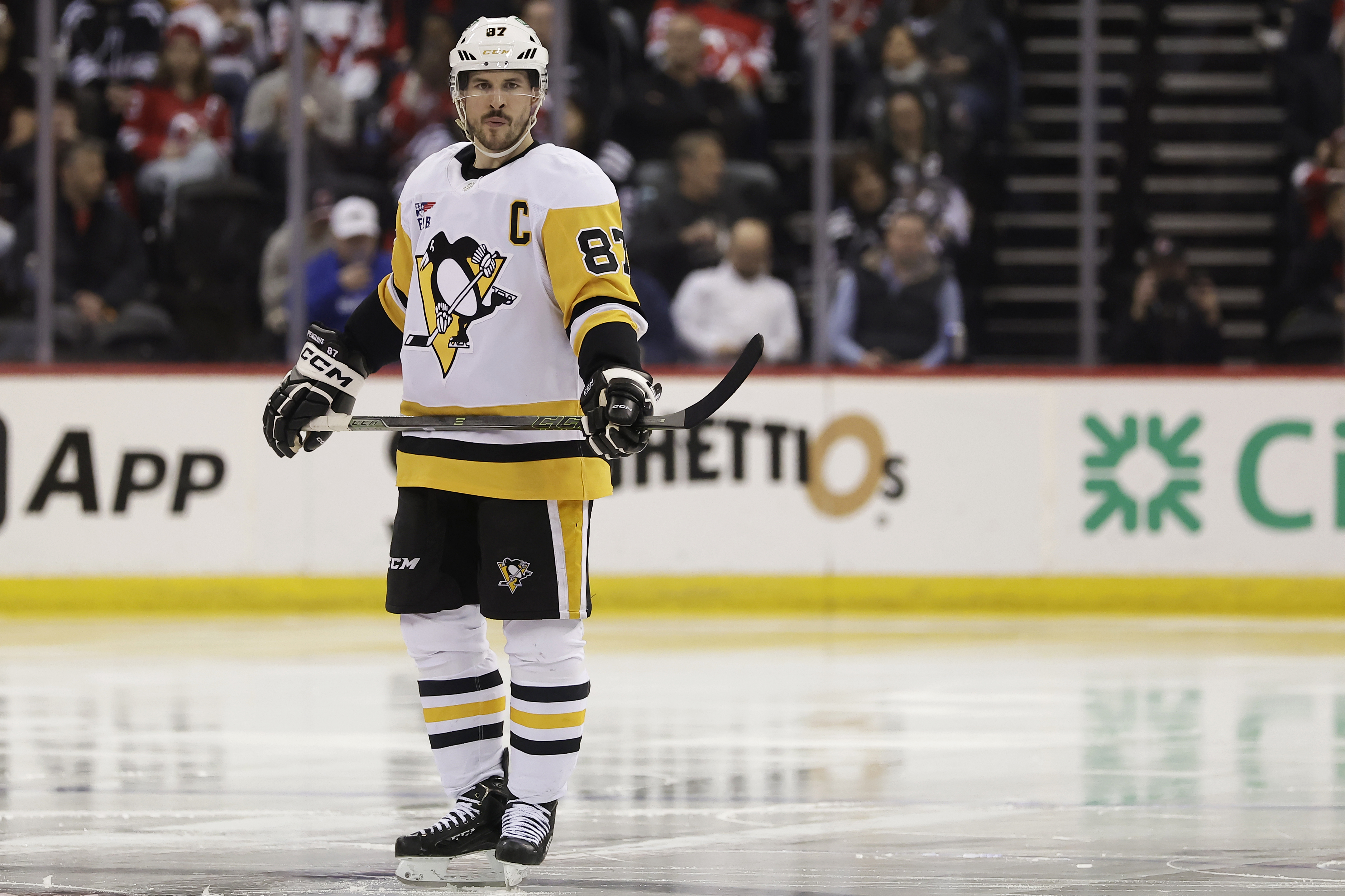 FILE - Pittsburgh Penguins center Sidney Crosby (87)waits for the the third period of an NHL hockey game against the New Jersey Devils, April 11, 2025, in Newark, N.J.