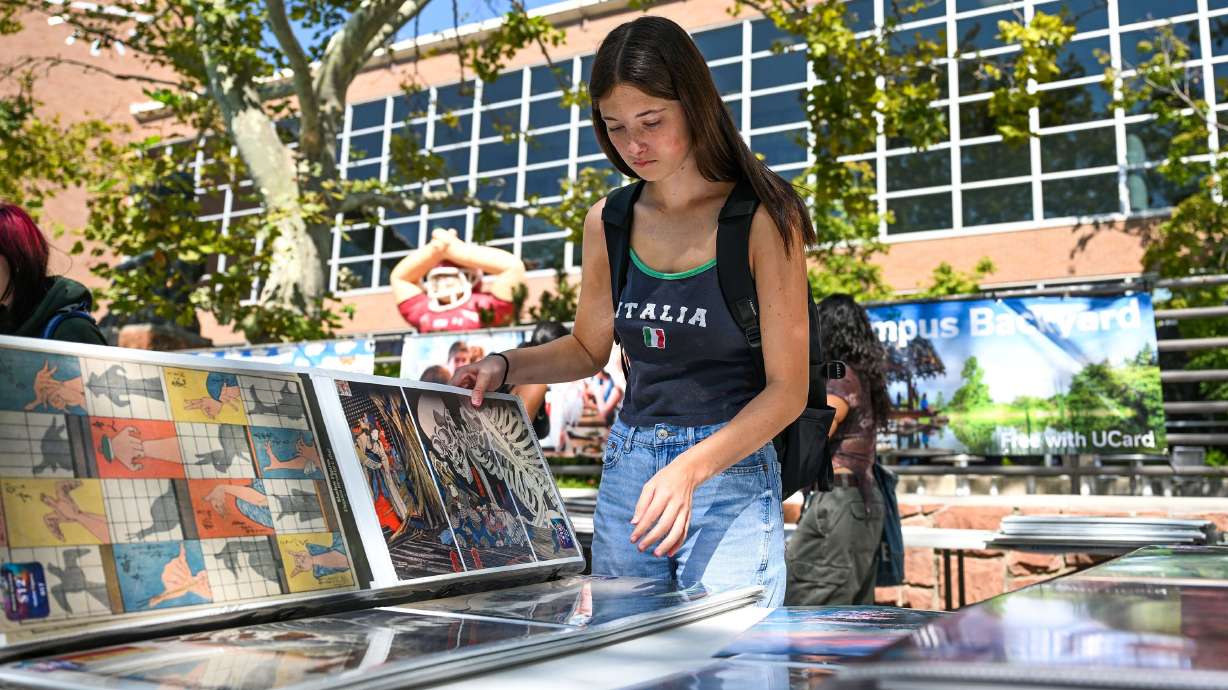 University of Utah student Madeline Staab looks at pieces of art to purchase outside the Student Union in Salt Lake City on Friday, Sept. 5.