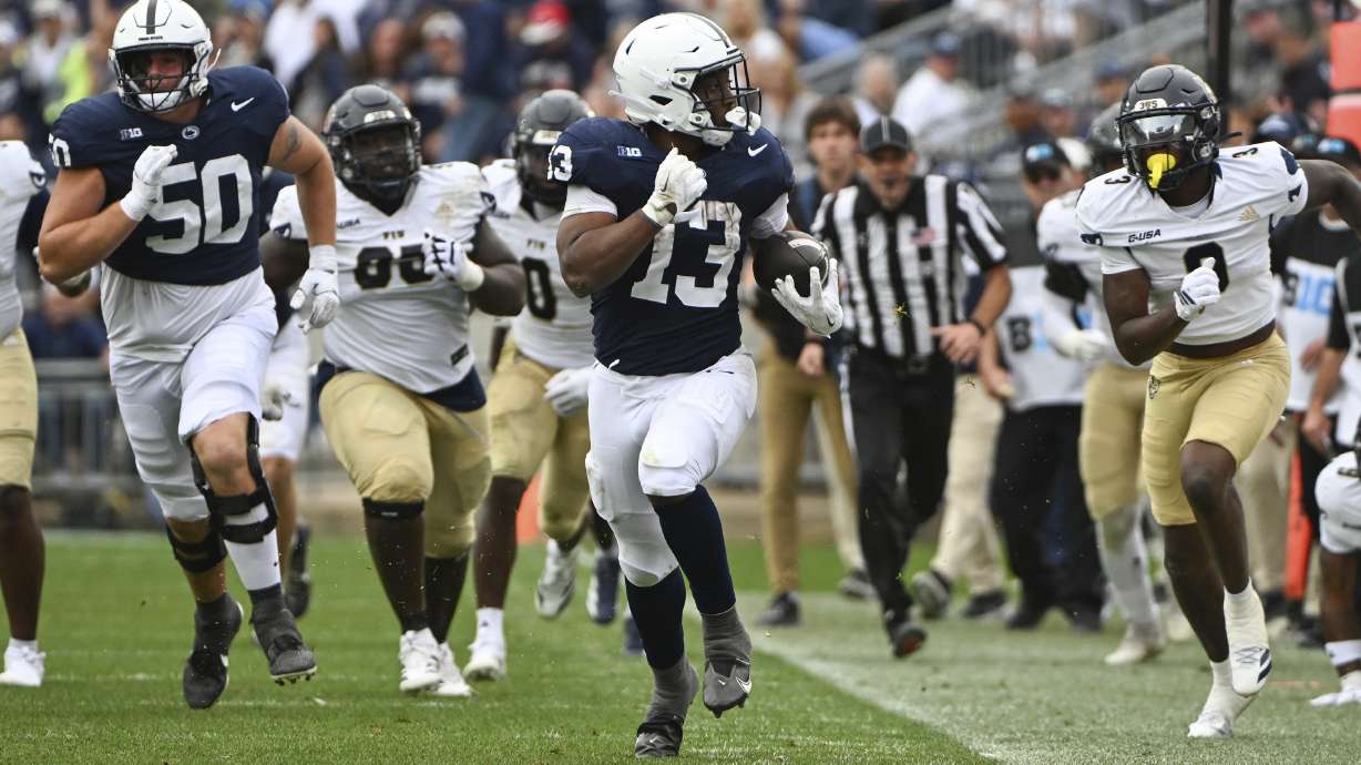 Penn State running back Kaytron Allen (13) eludes Florida International defensive back Demetrius Hill (3) on his way to score a touchdown during the fourth quarter of an NCAA college football game, Saturday, Sept. 6, 2025, in State College, Pa.