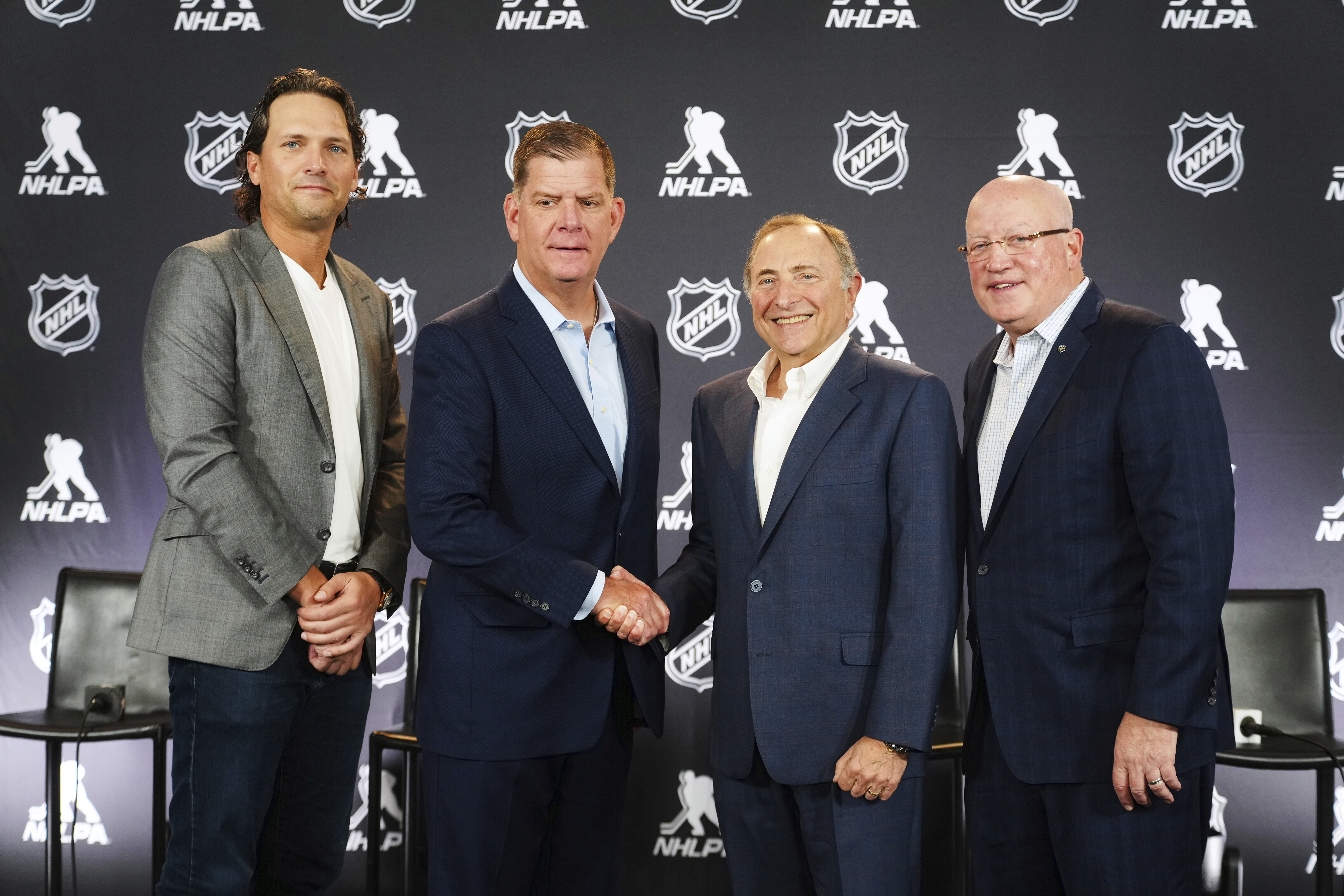 FILE - From left to right, Ron Hainsey, NHLPA Assistant Executive Director, Marty Walsh, NHLPA Executive Director, Gary Bettman, NHL Commissioner, and Bill Daly, NHL Deputy Commissioner, pose for photos after a joint press conference before the NHL hockey draft, June 27, 2025, in Los Angeles.