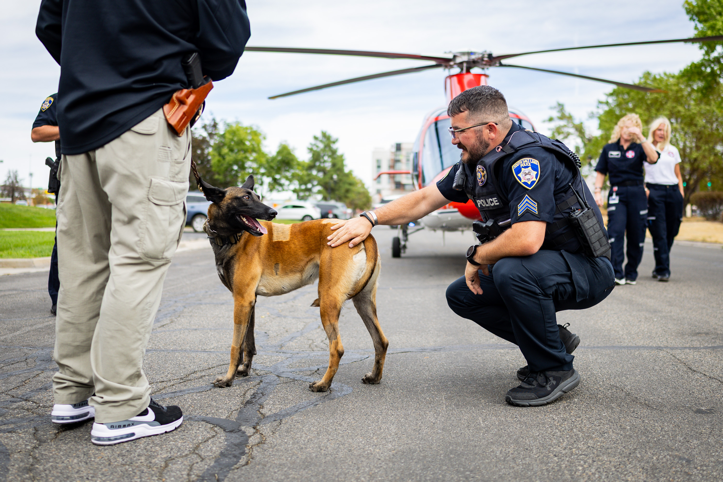 Three weeks after being seriously injured during a deadly domestic violence call in Tremonton, Utah, K-9 Azula, and her partner, officer Mike Allred, who was also injured, reunites with Sgt. David Wirthlin from the South Salt Lake Police Department, right, and others from the Intermountain Health Flight and Ambulance Service and MedVet Salt Lake City on Tuesday.
