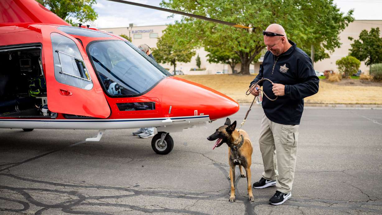K-9 Azula and her partner, Mike Allred, on Tuesday, stand by a helicopter that transported Azula to MedVet Salt Lake City, three weeks after she and Allred were seriously injured during a deadly domestic violence call in Tremonton.