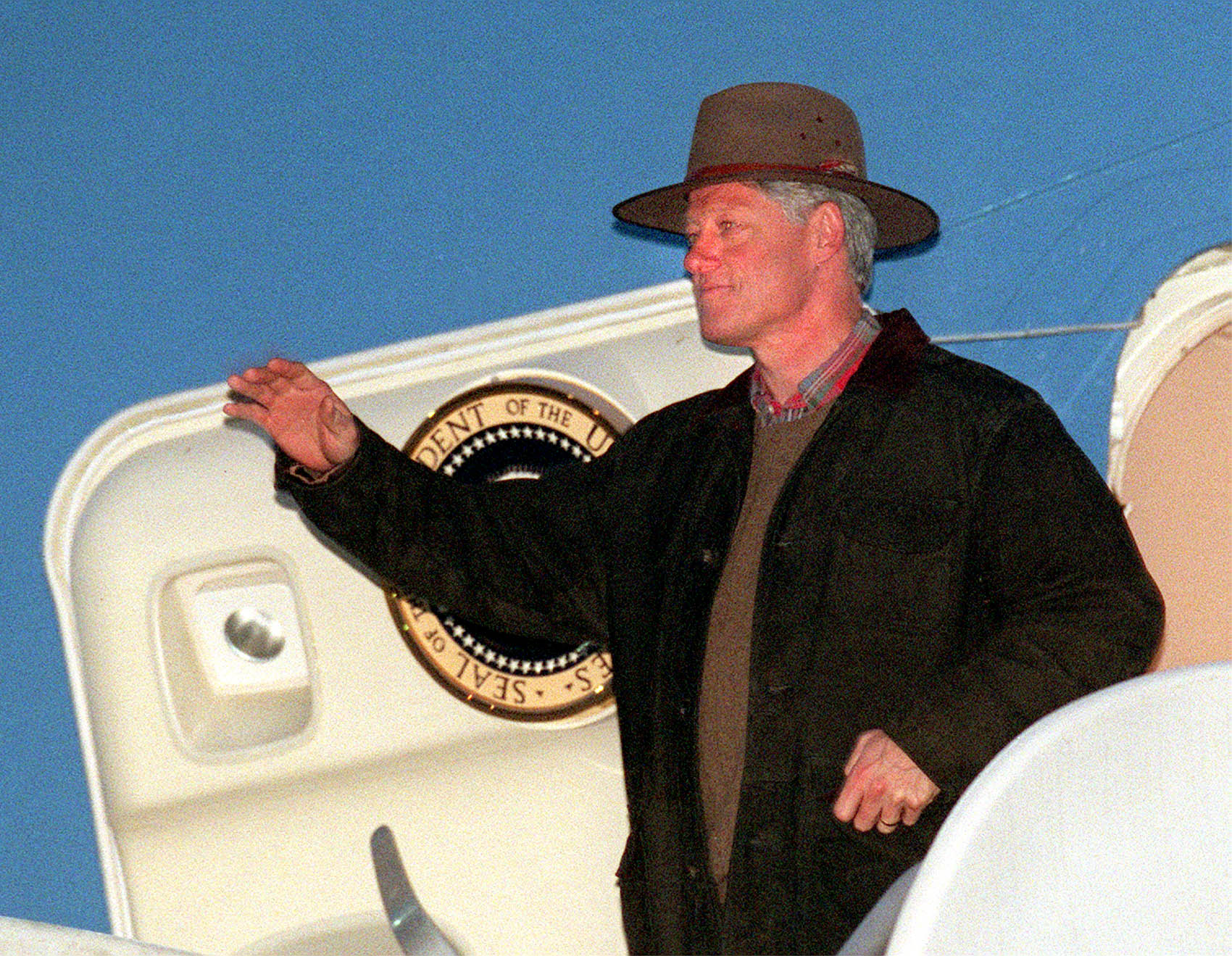 President Bill Clinton waves as he steps out of Air Force One after he arrived at Salt Lake International Airport on Feb. 26, 1998.