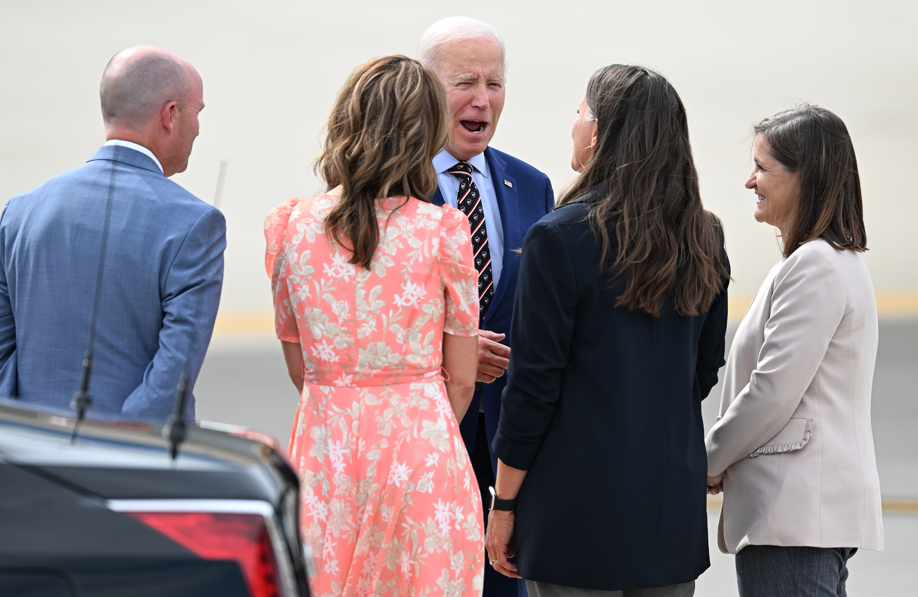 President Joe Biden talks with Utah Gov. Spencer Cox, first lady Abby Cox, Salt Lake City Mayor Erin Mendenhall and Salt Lake County Mayor Jenny Wilson after his arrival on Air Force One at Roland R. Wright Air National Guard Base in Salt Lake City on Aug. 9, 2023.