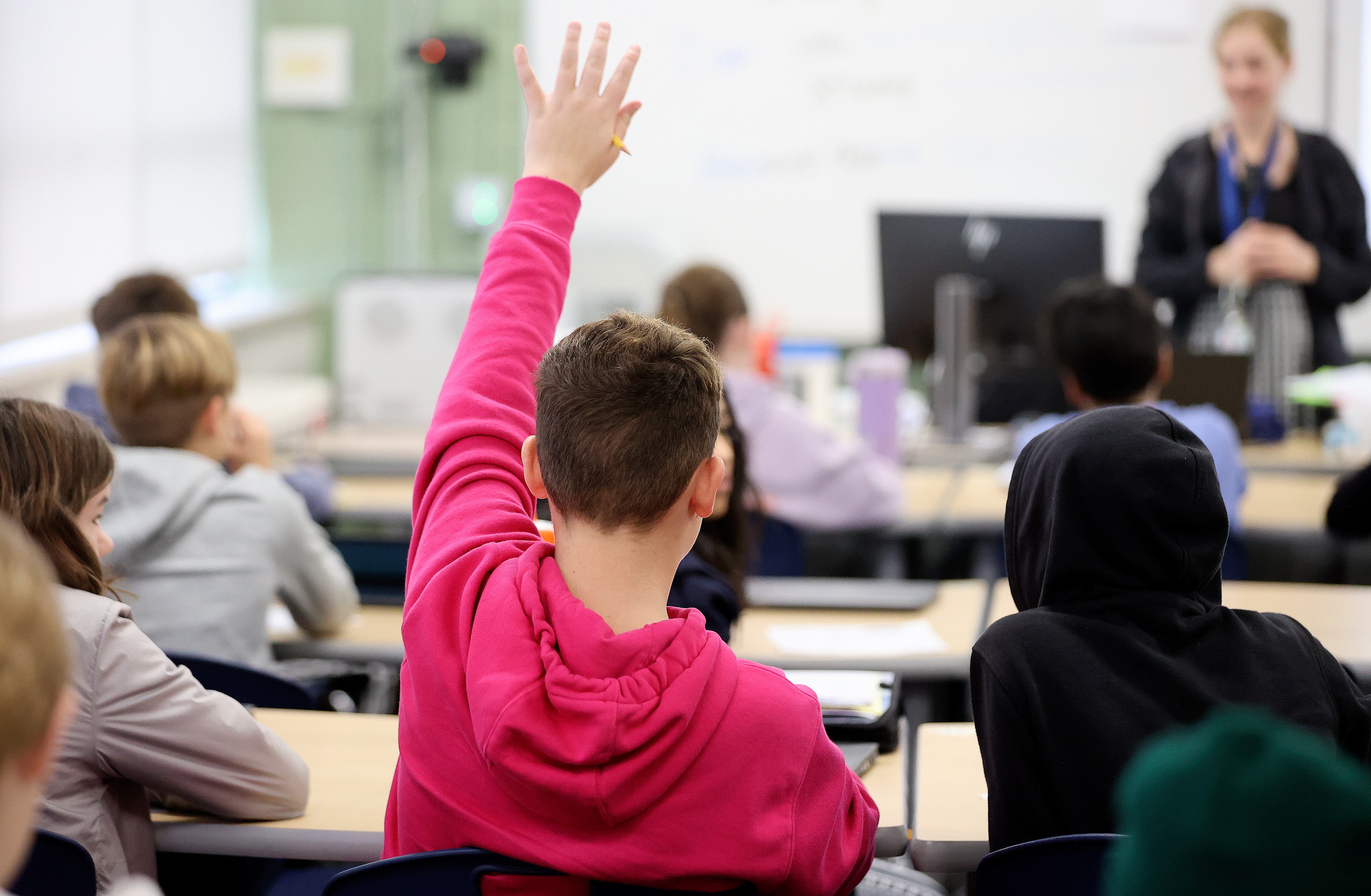 A sixth grade student raises his hand during Utah studies class at Evergreen Junior High School in Millcreek on Jan. 10, 2024.
