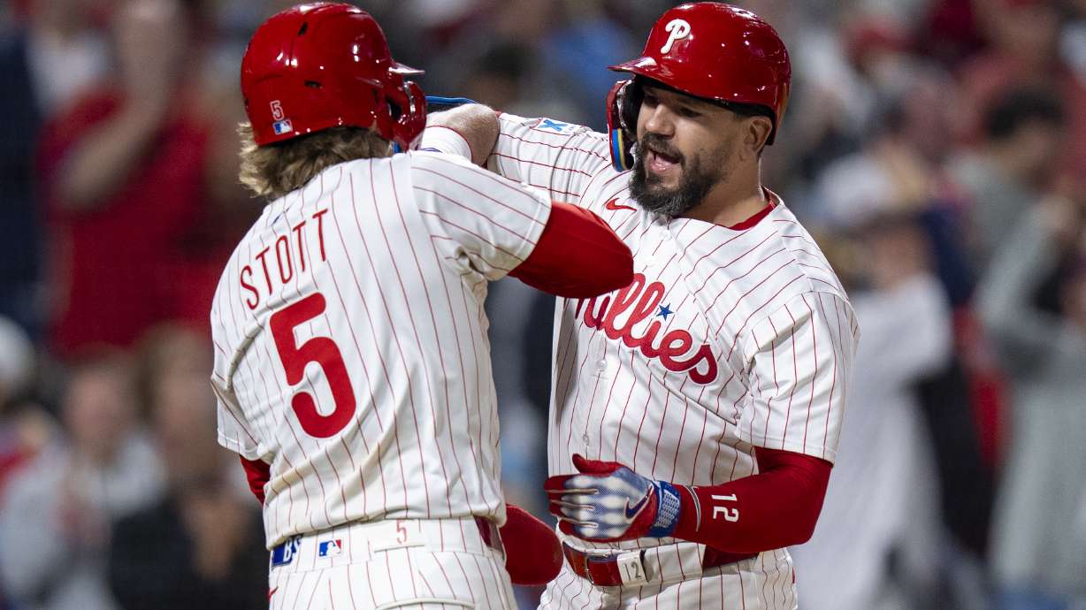 Philadelphia Phillies' Kyle Schwarber, right, reacts to his three-run home run with Bryson Stott, left, during the seventh inning of a baseball game against the New York Mets, Tuesday, Sep. 9, 2025, in Philadelphia.