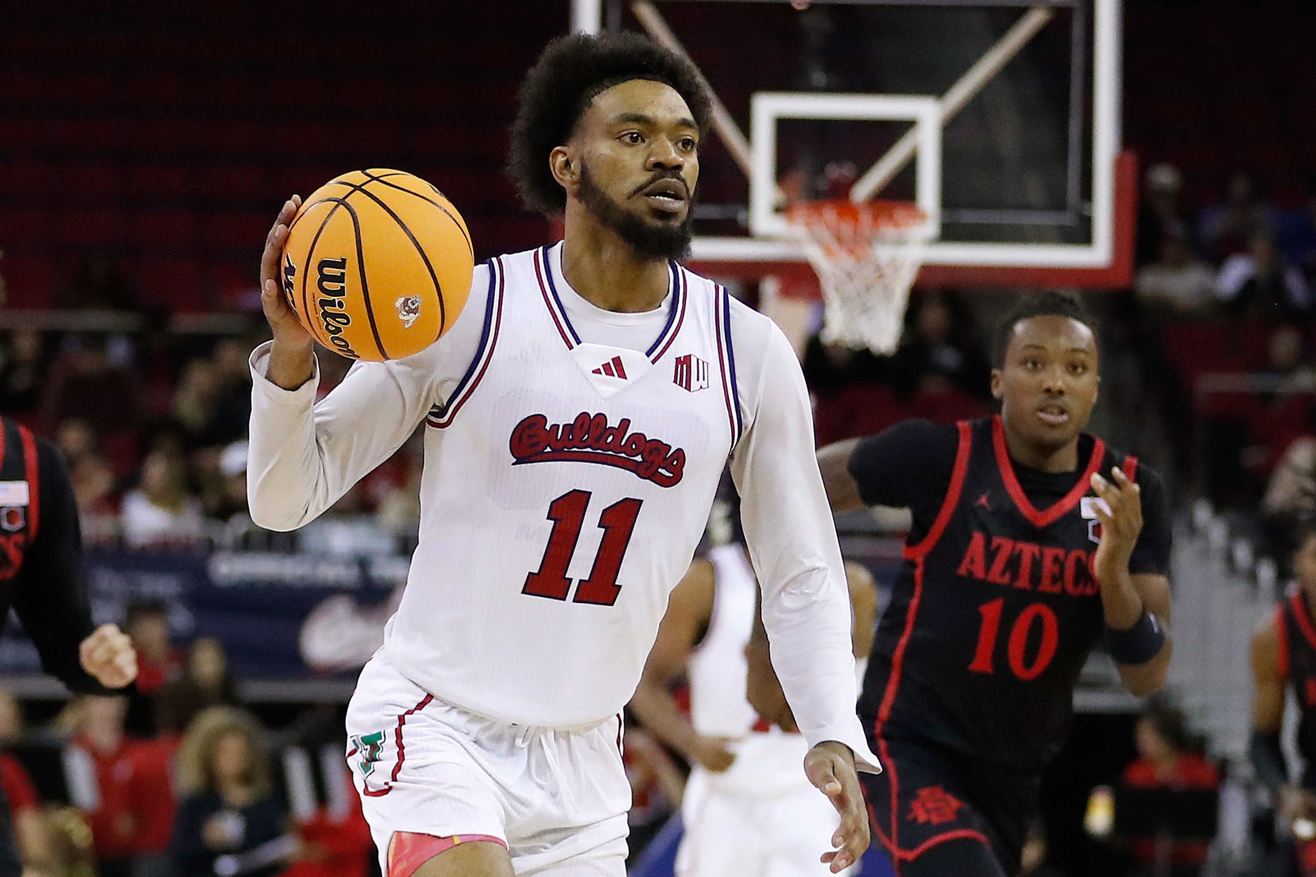 FILE - Fresno State's Mykell Robinson drives against San Diego State during the second half of an NCAA college basketball game in Fresno, Calif., Wednesday, Dec. 4, 2024. 