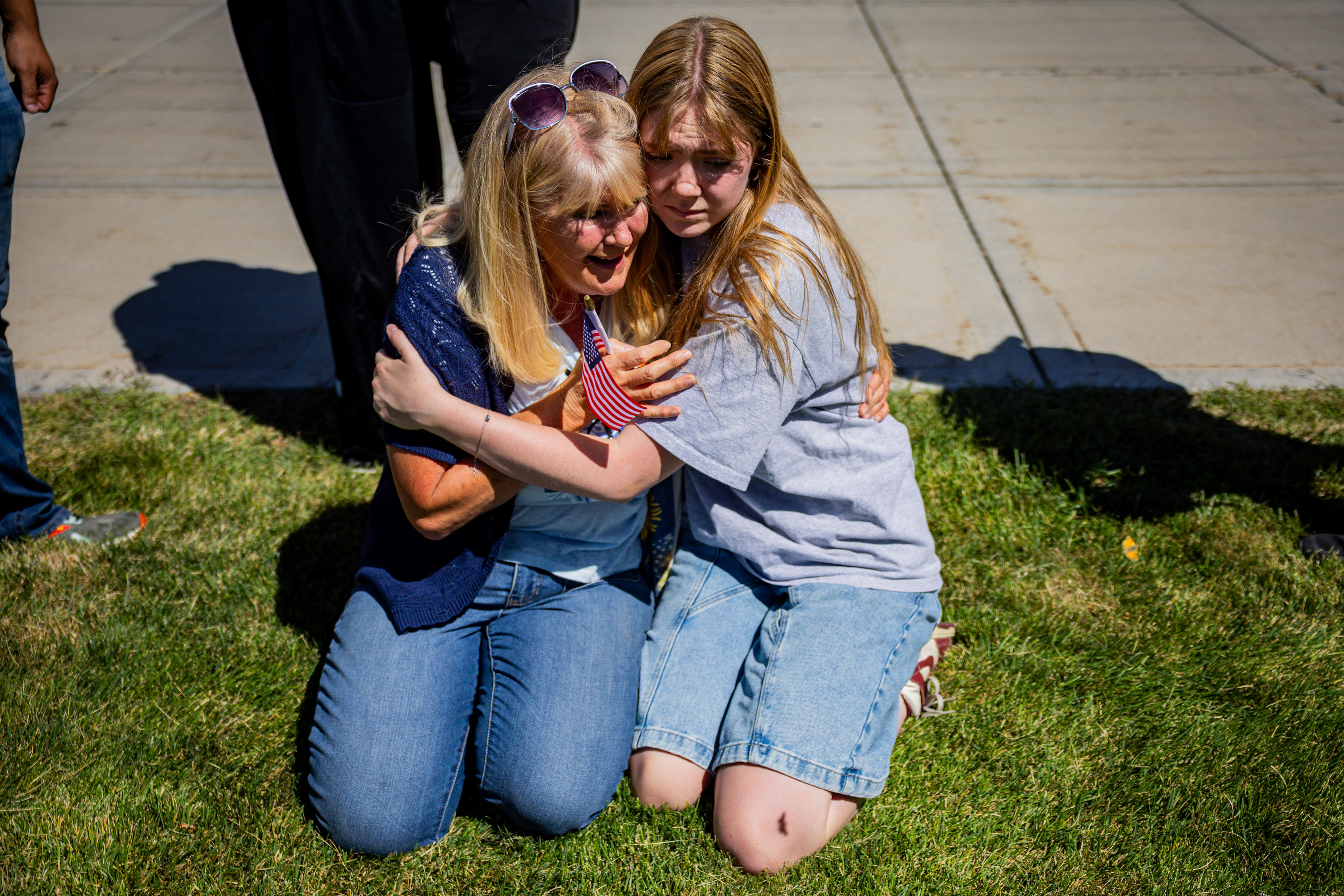 Strangers Cheryl Stout, left, and Charlotte Miller, right, comfort each other after Charlie Kirk is shot during Turning Point's visit to Utah Valley University in Orem on Wednesday.